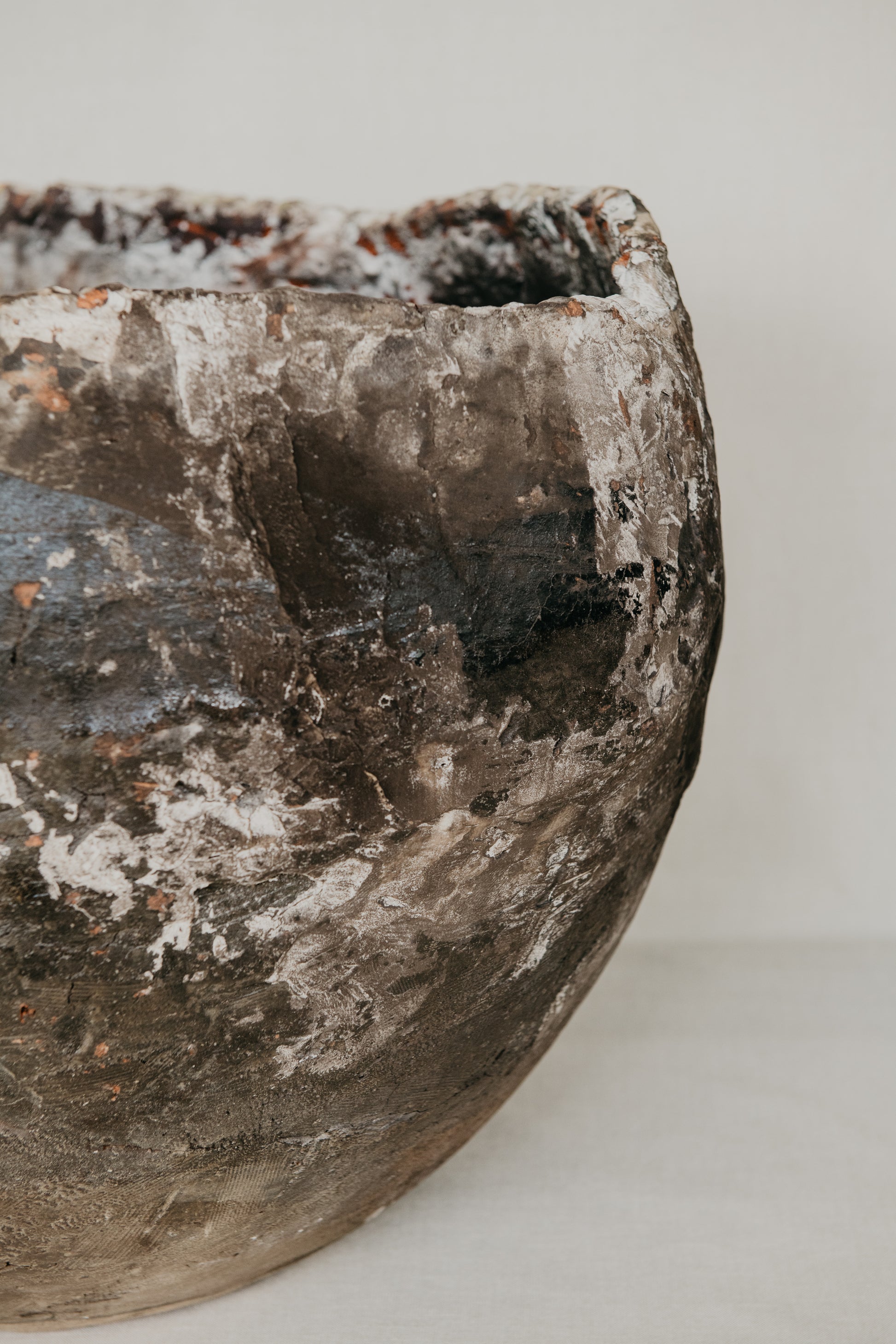 Vintage terracotta pot with a textured surface on a white background
