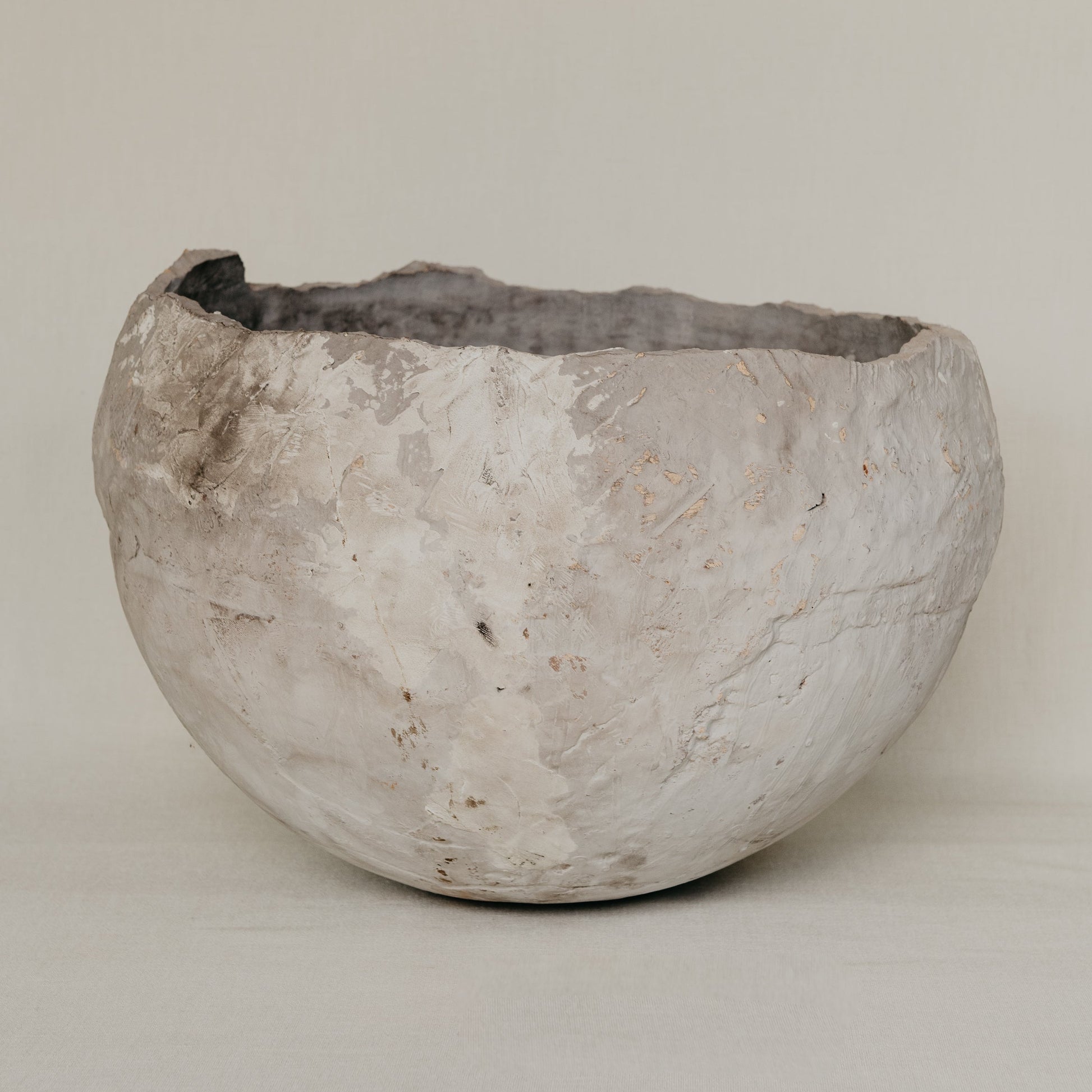 Textured stone bowl on a plain background