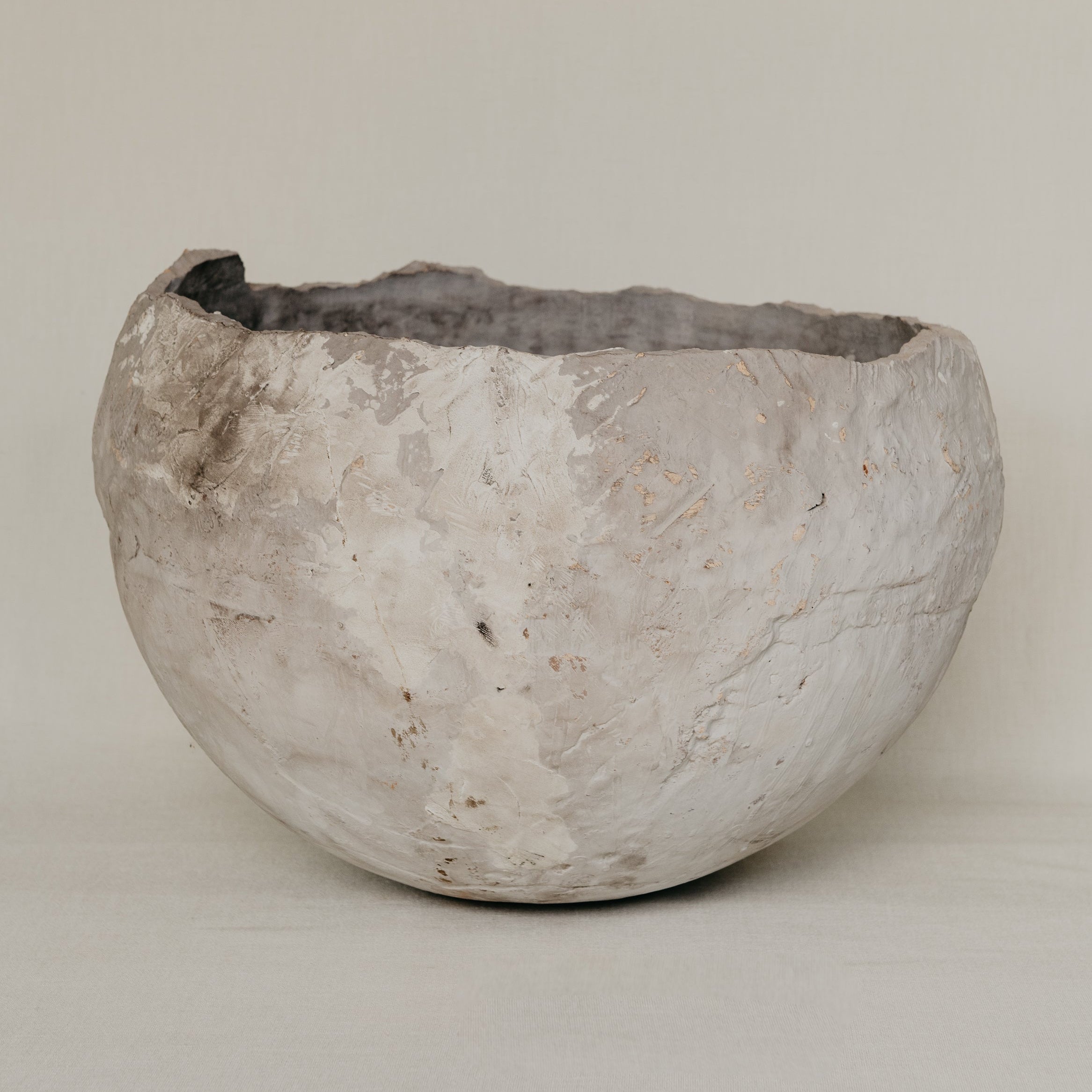 Textured stone bowl on a plain background