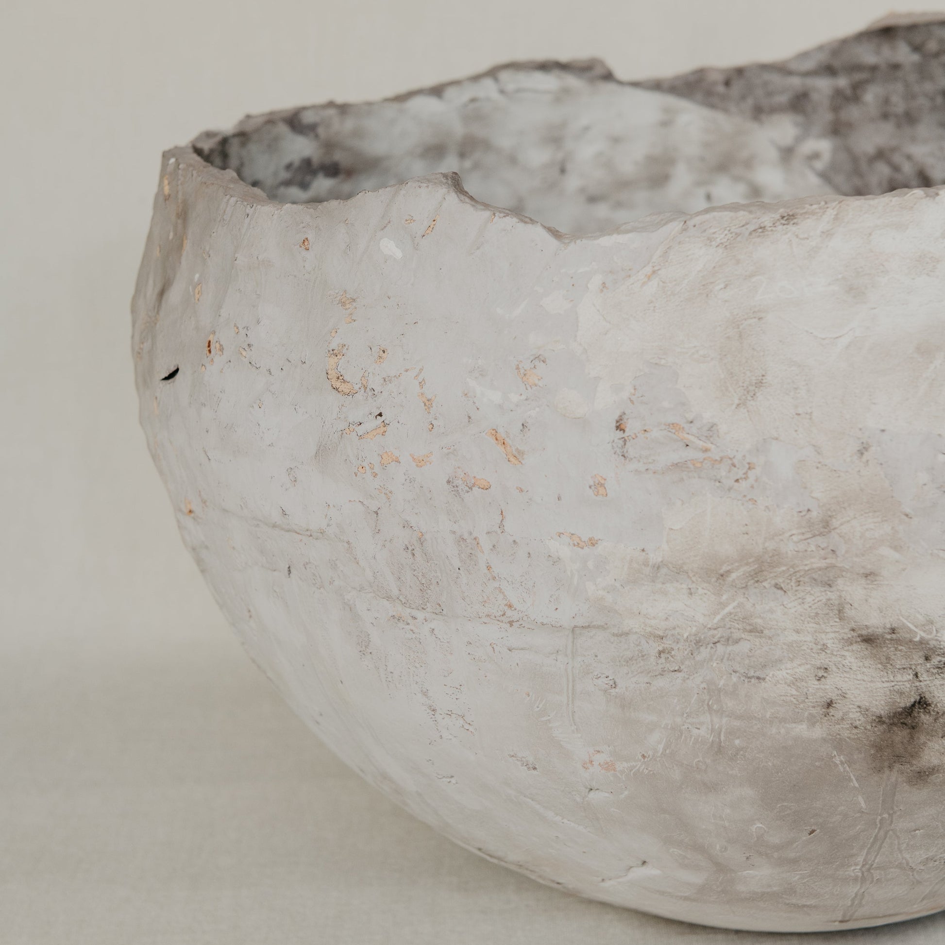 Ceramic bowl with textured surface on a plain background