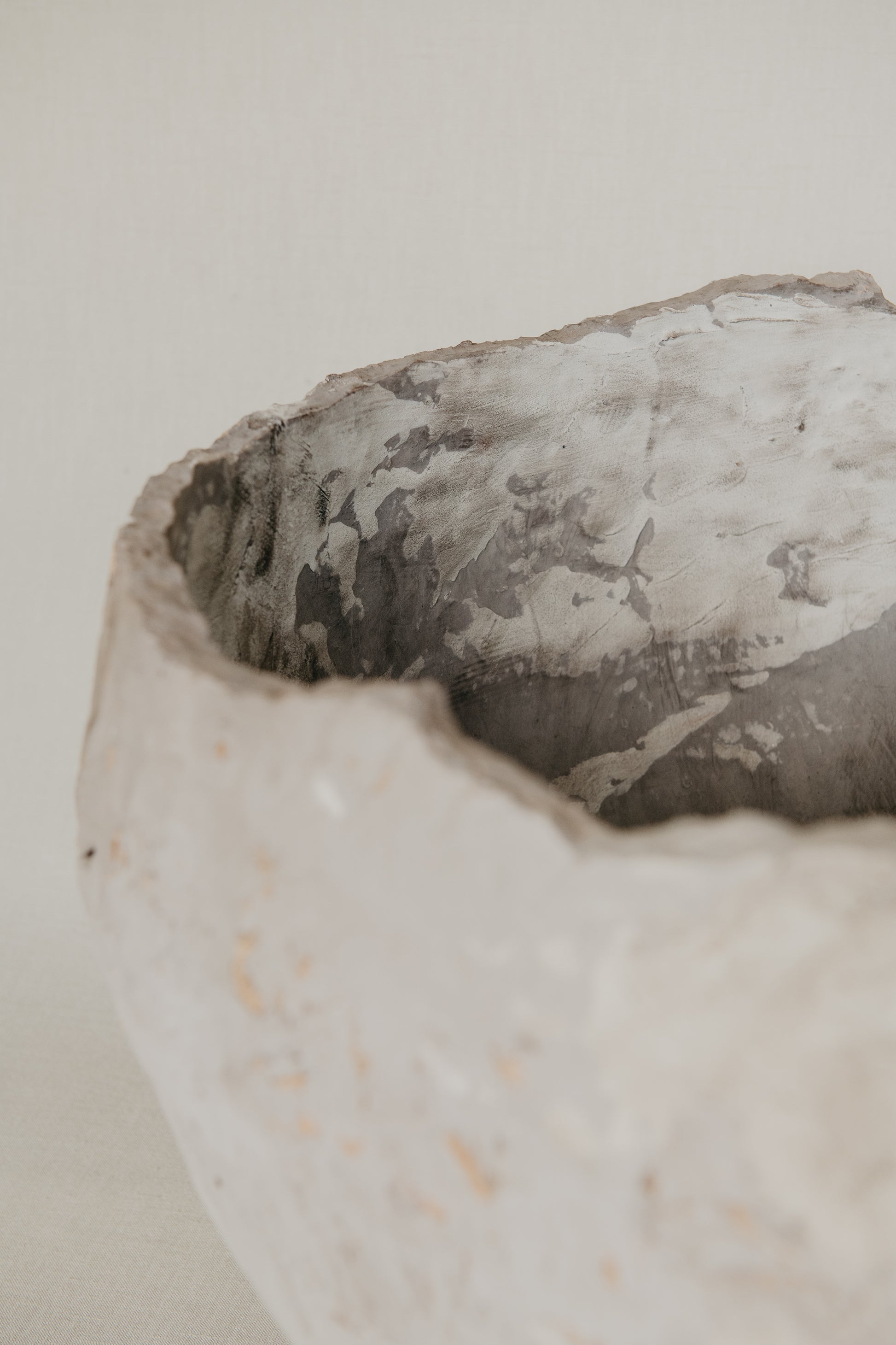Close-up of a textured ceramic bowl on a light background