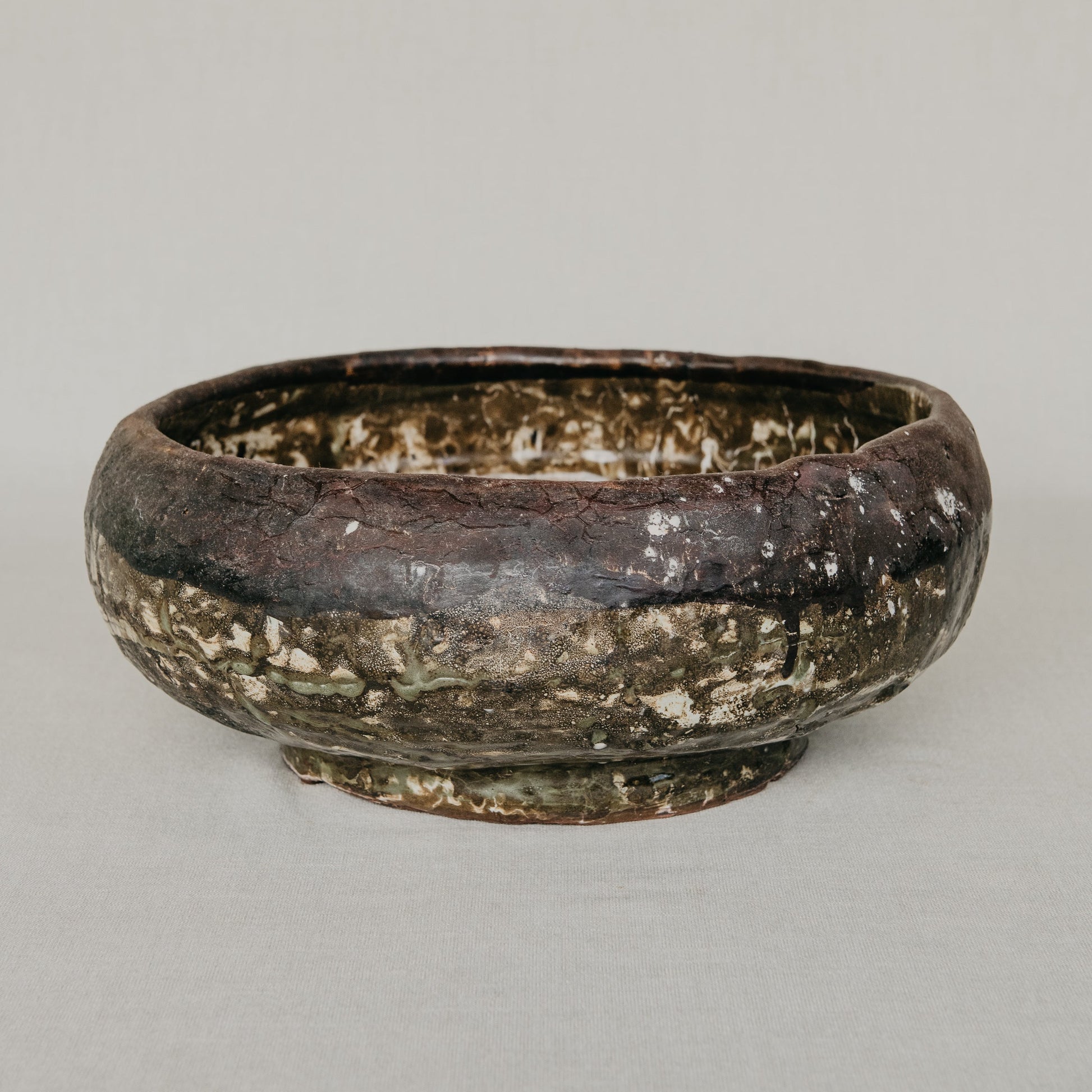 Brown ceramic bowl on a gray background