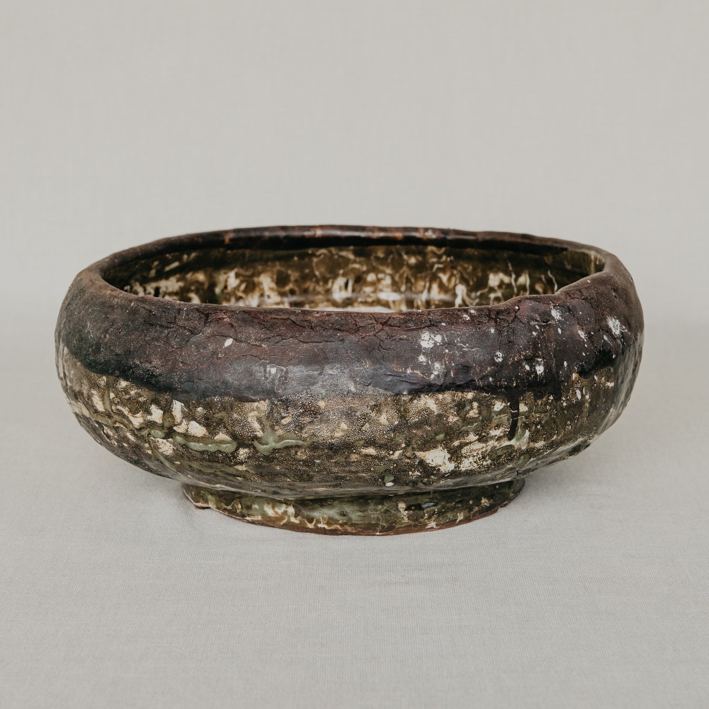 Brown ceramic bowl on a gray background