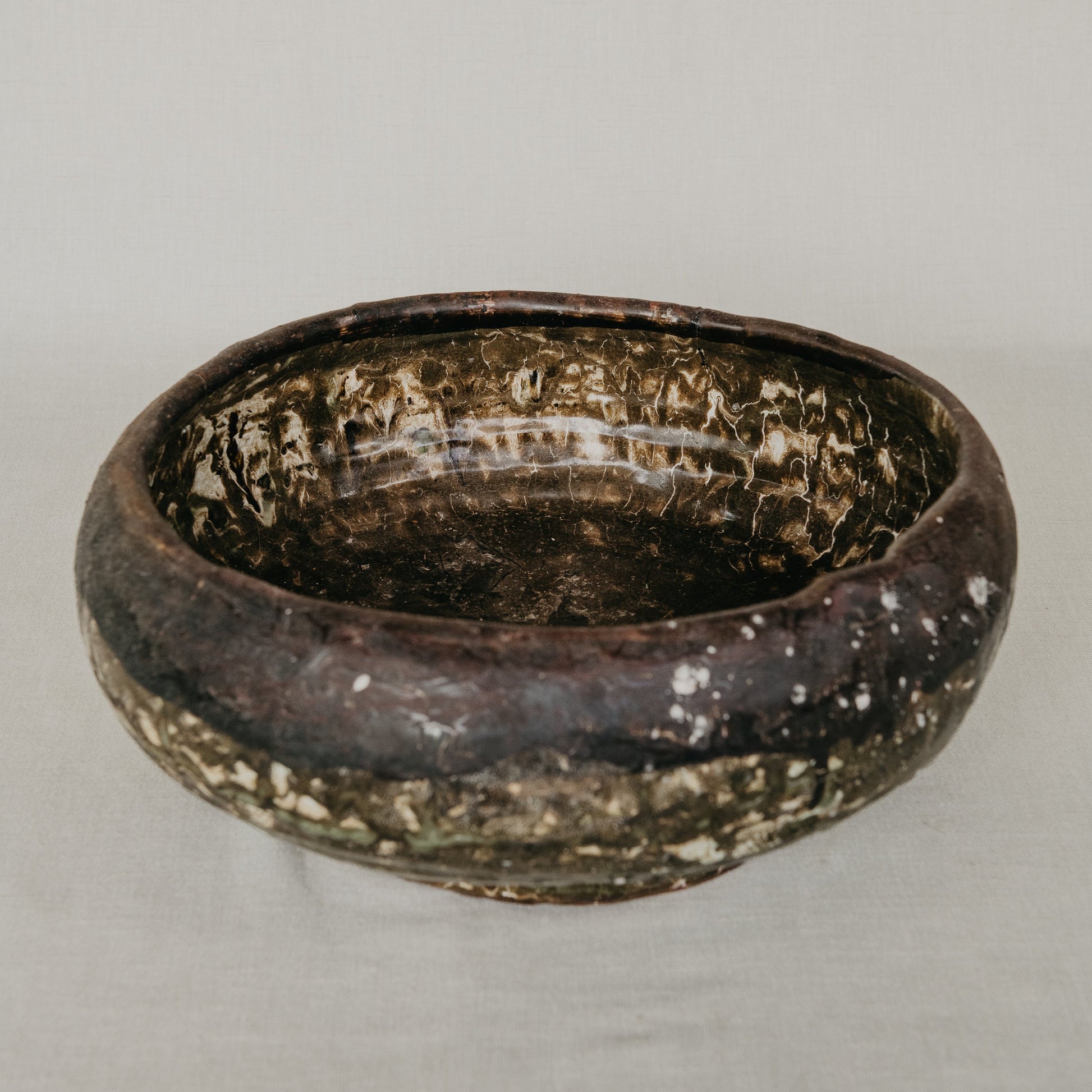 Brown ceramic bowl on a gray background