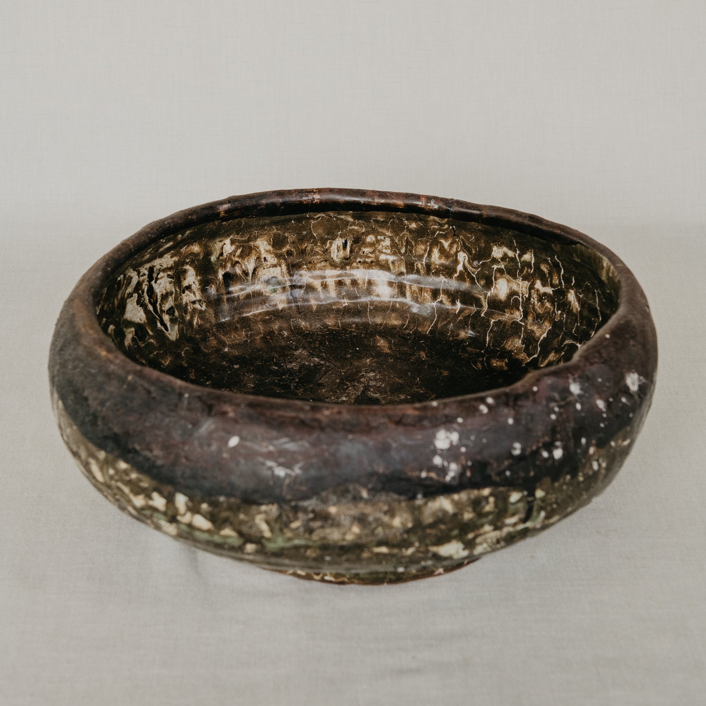 Brown ceramic bowl on a gray background