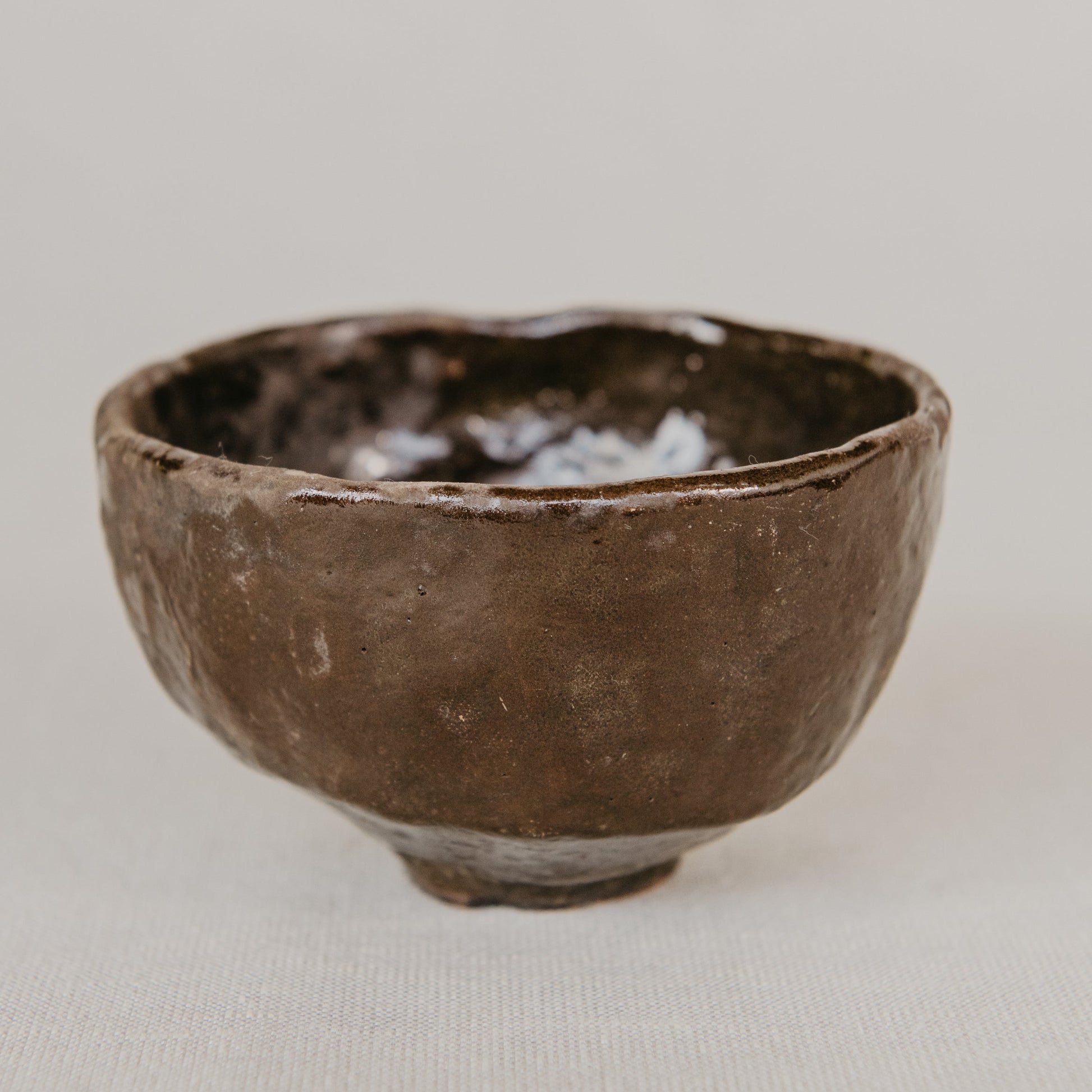 Brown ceramic bowl on a light gray background