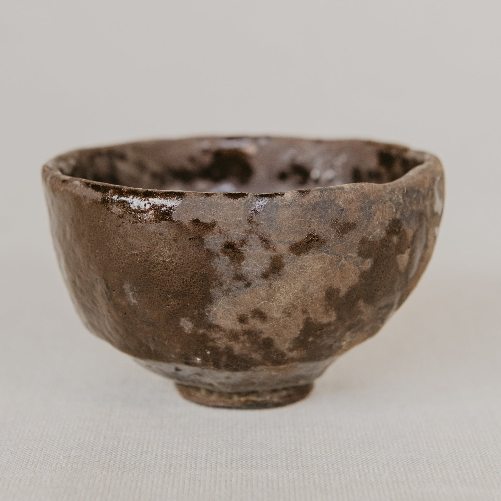 Brown ceramic bowl on a light gray background