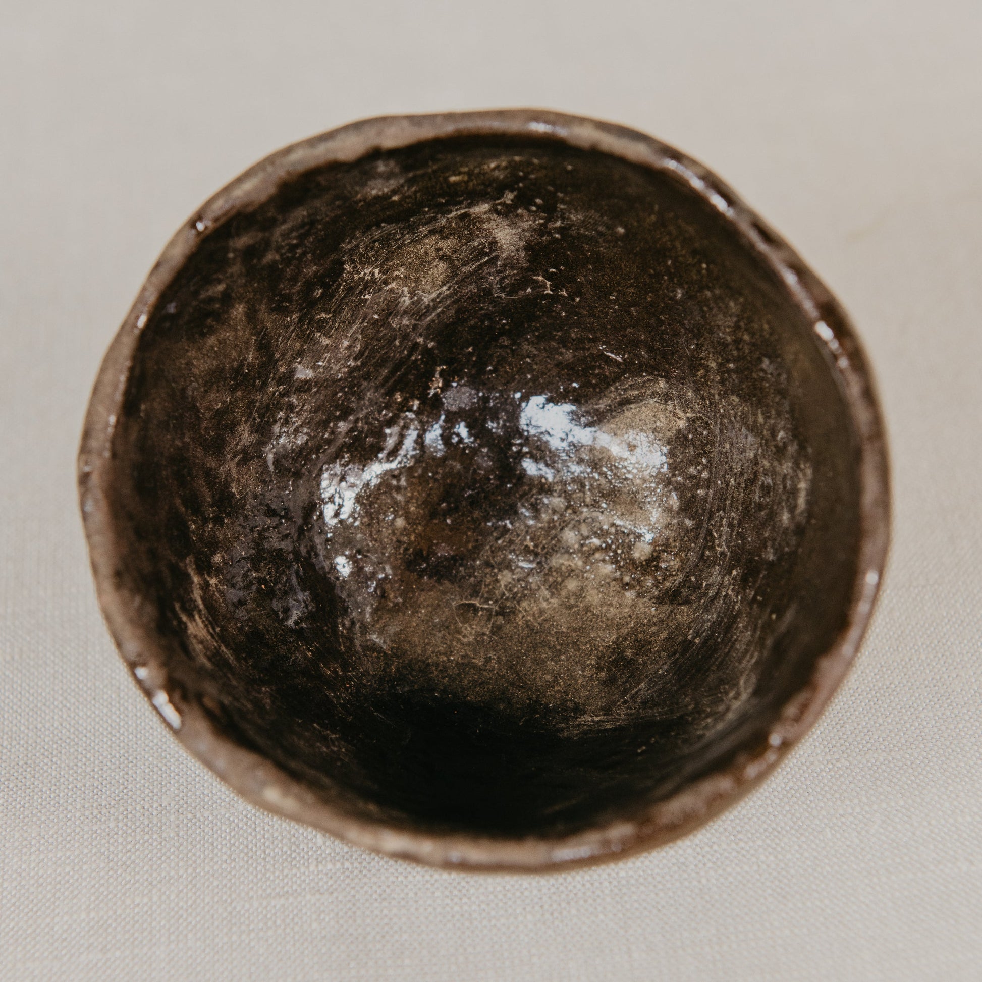 Brown ceramic bowl on a light gray background