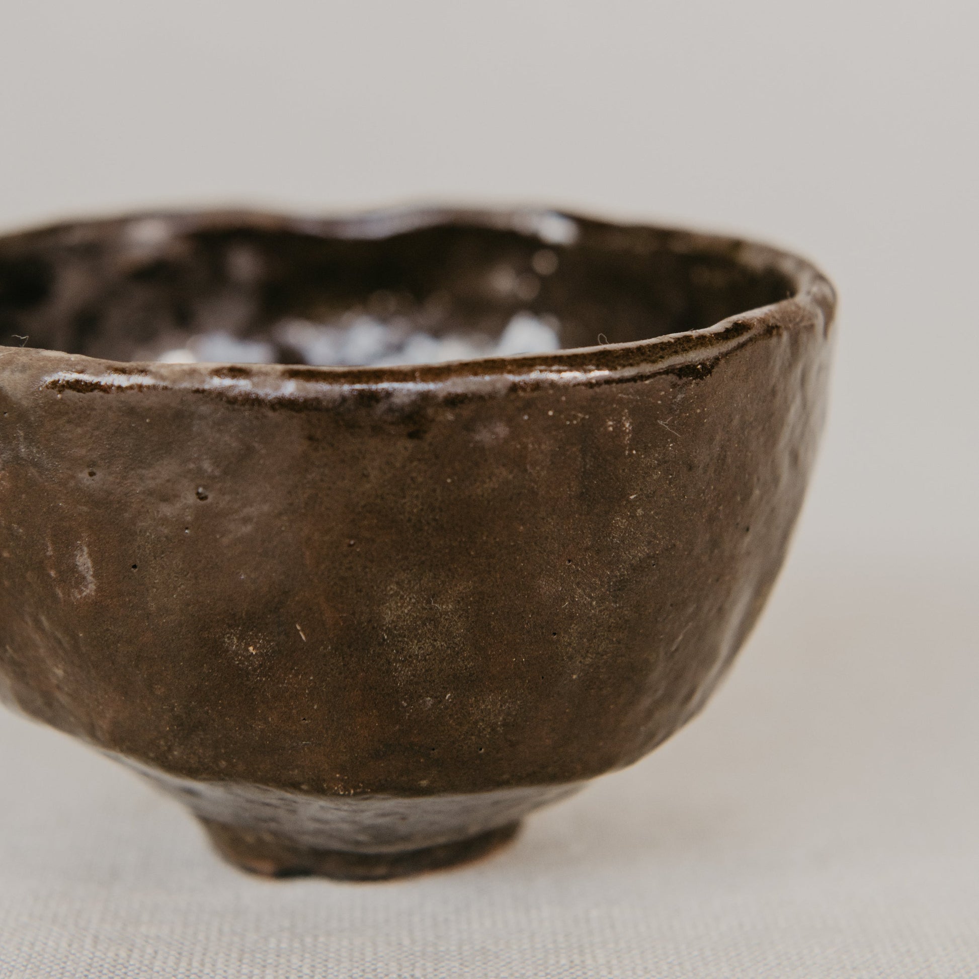 Brown ceramic bowl on a light beige background