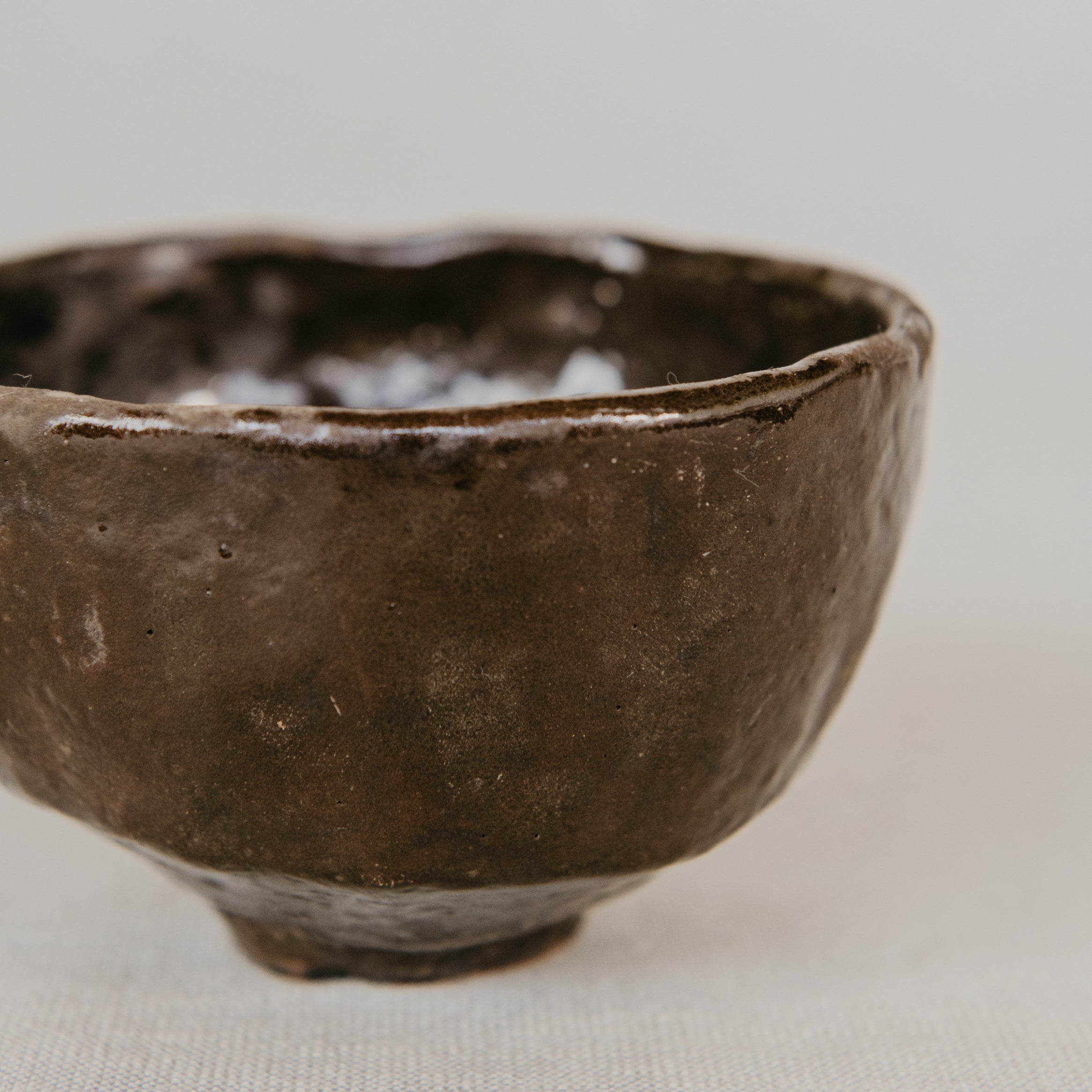 Brown ceramic bowl on a light beige background