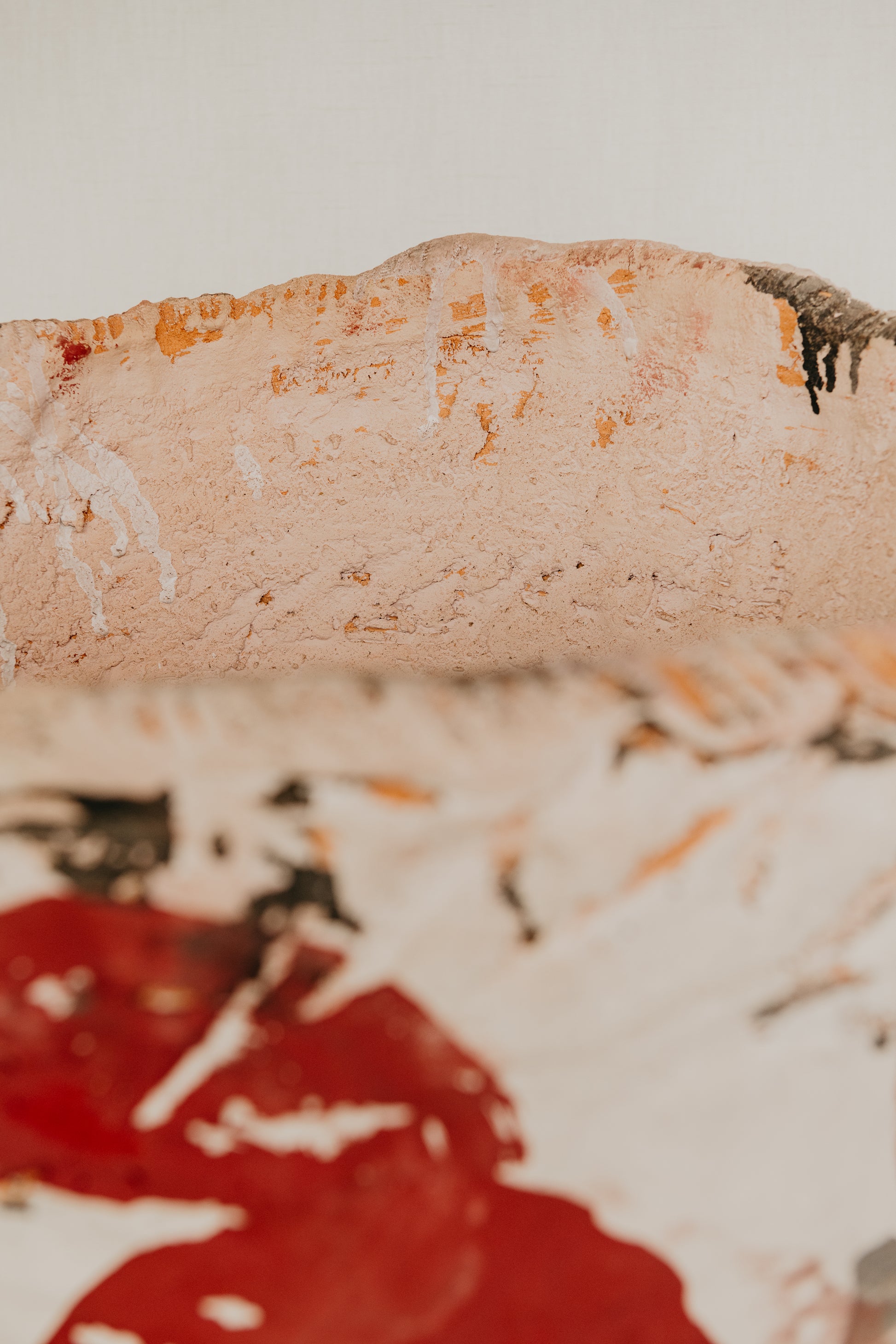 Close-up of a piece of bread with a red sauce on a white background
