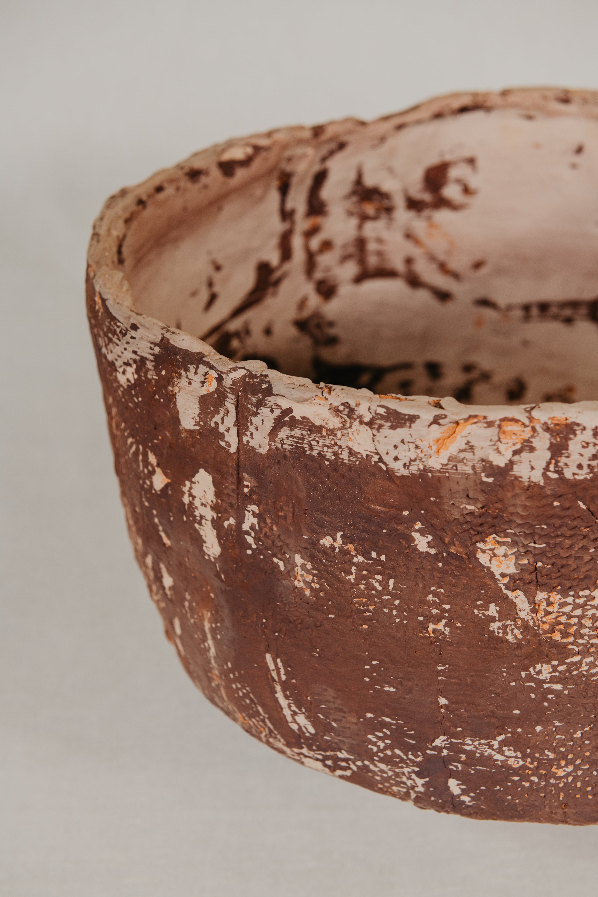 Ceramic cup with textured surface on a beige background