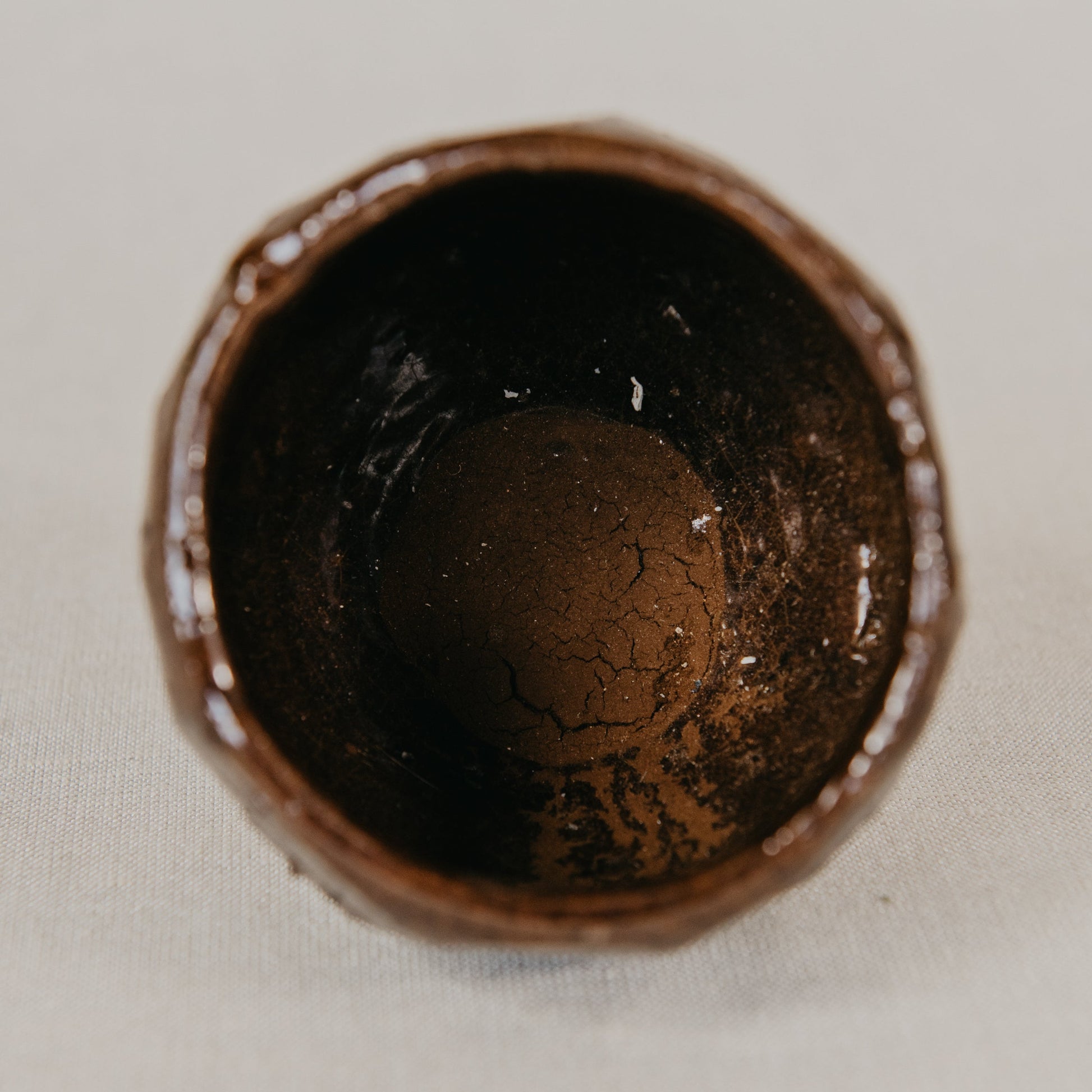 Close-up of a chocolate truffle in a shell on a light background