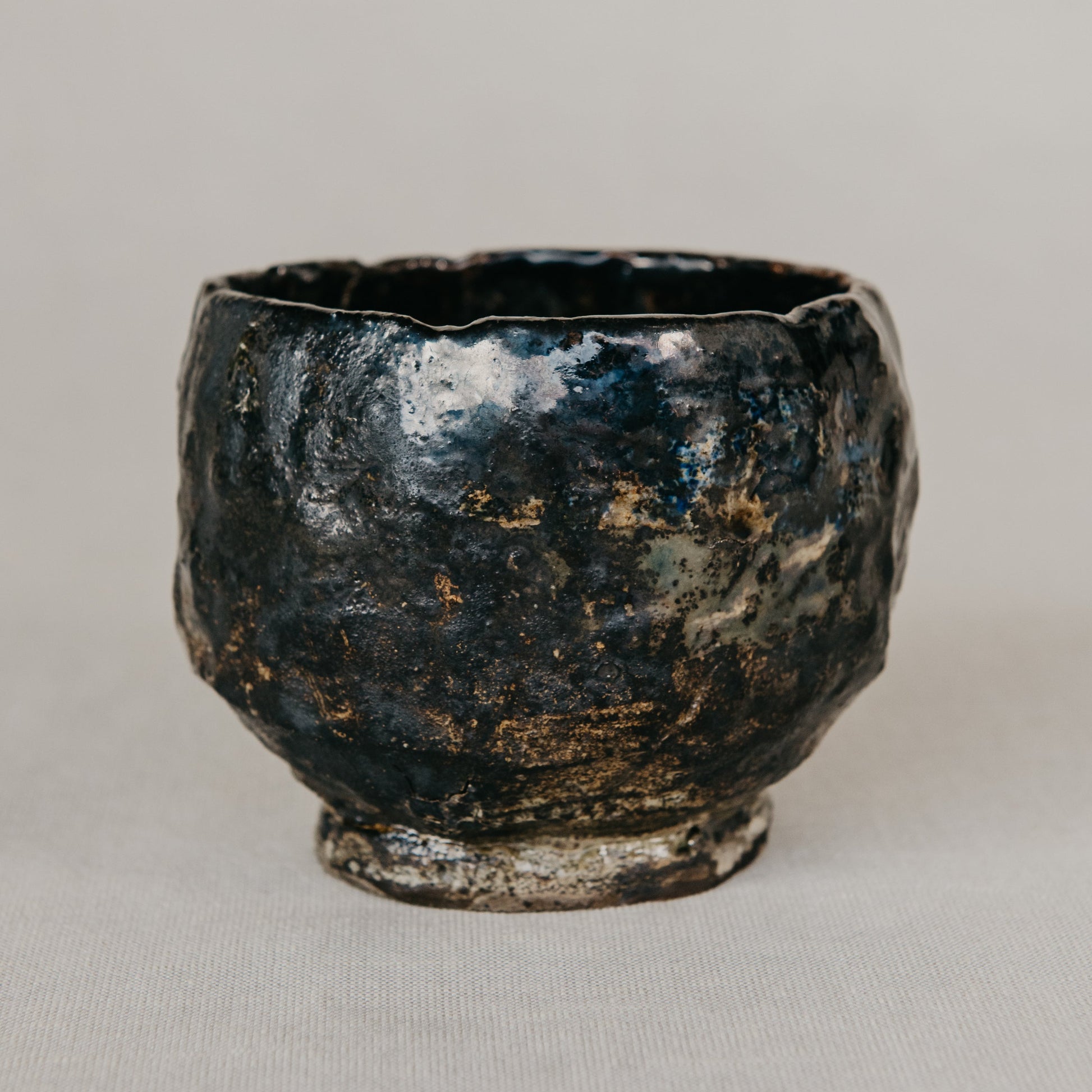 Black ceramic cup on a light gray background