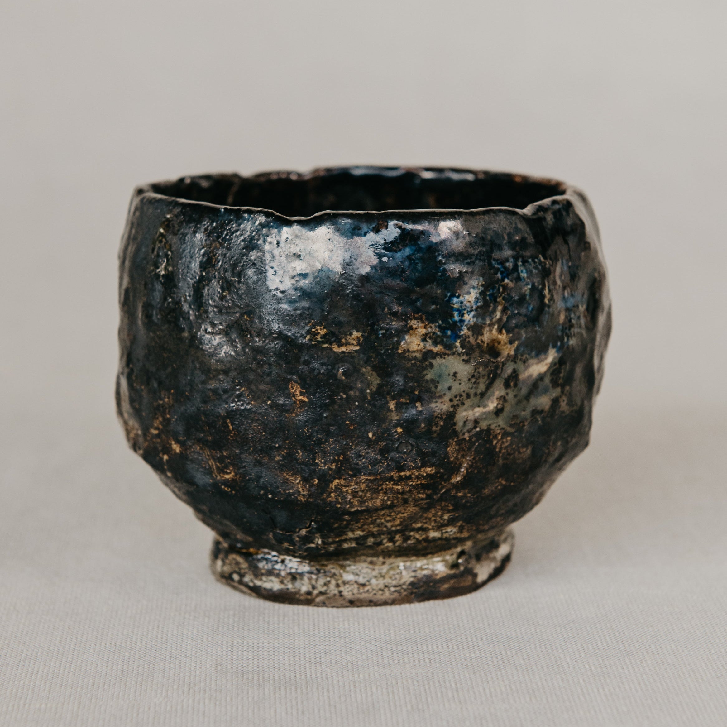 Black ceramic cup on a light gray background