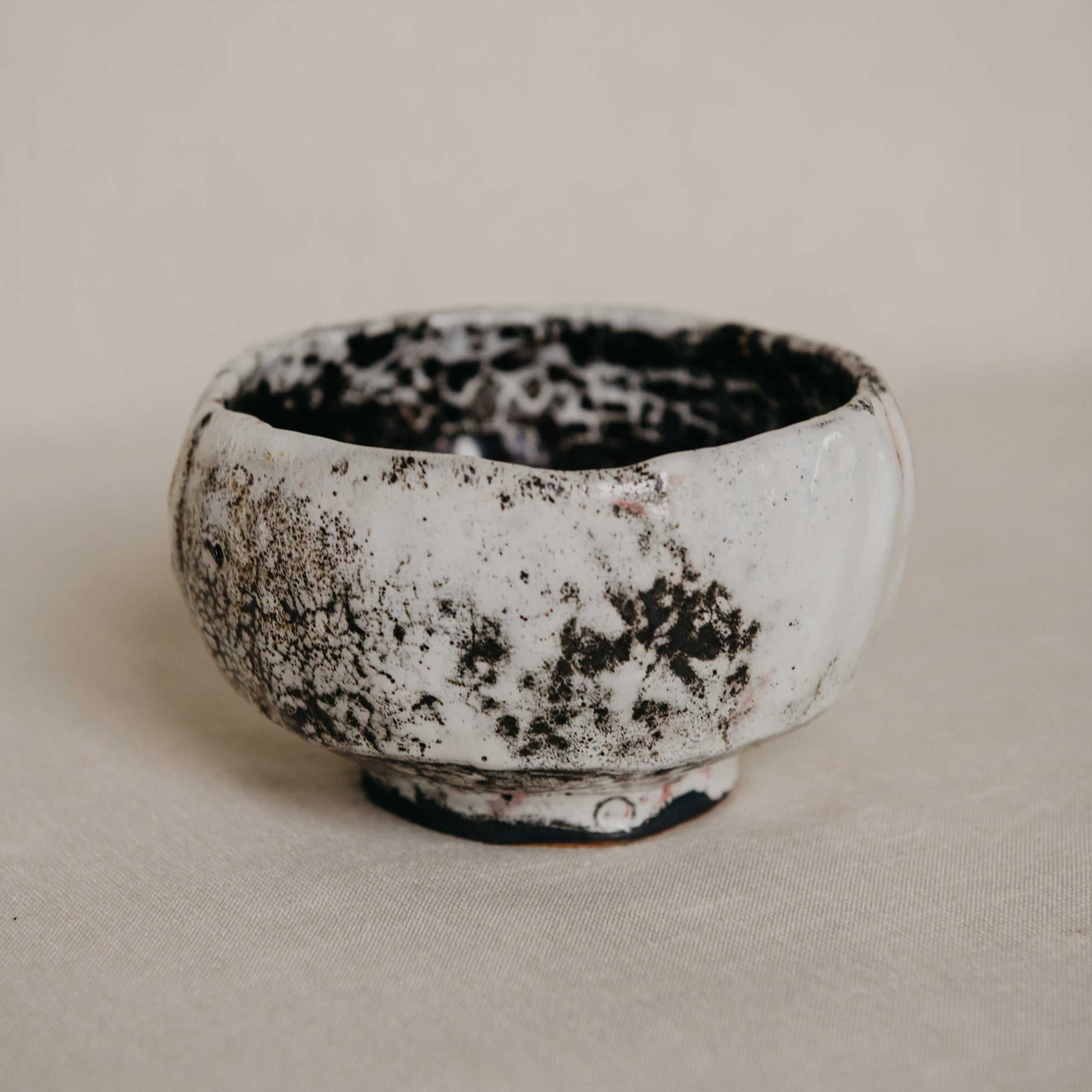 Ceramic bowl with a textured surface on a plain background
