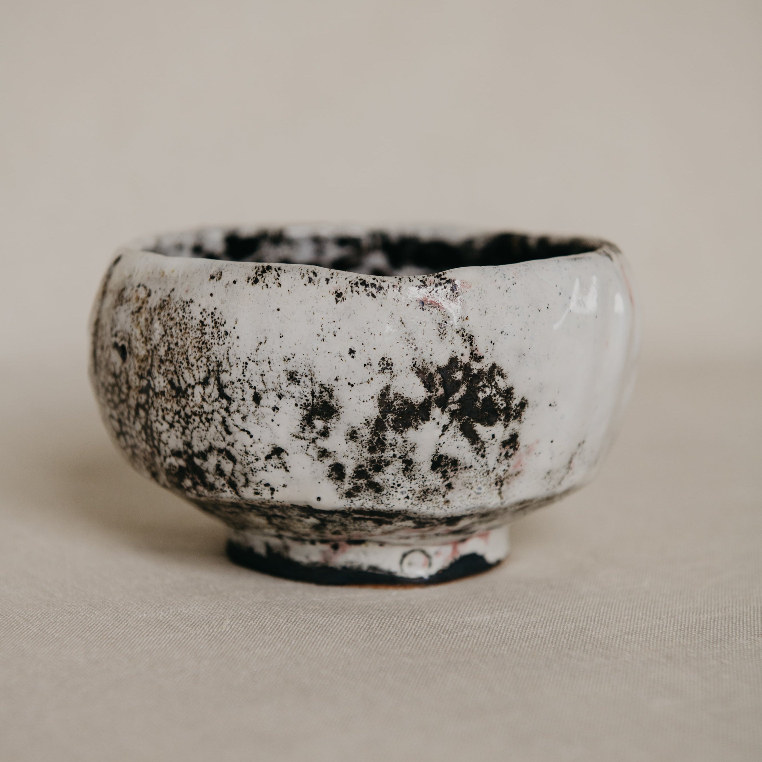 Ceramic bowl with a textured surface on a beige background