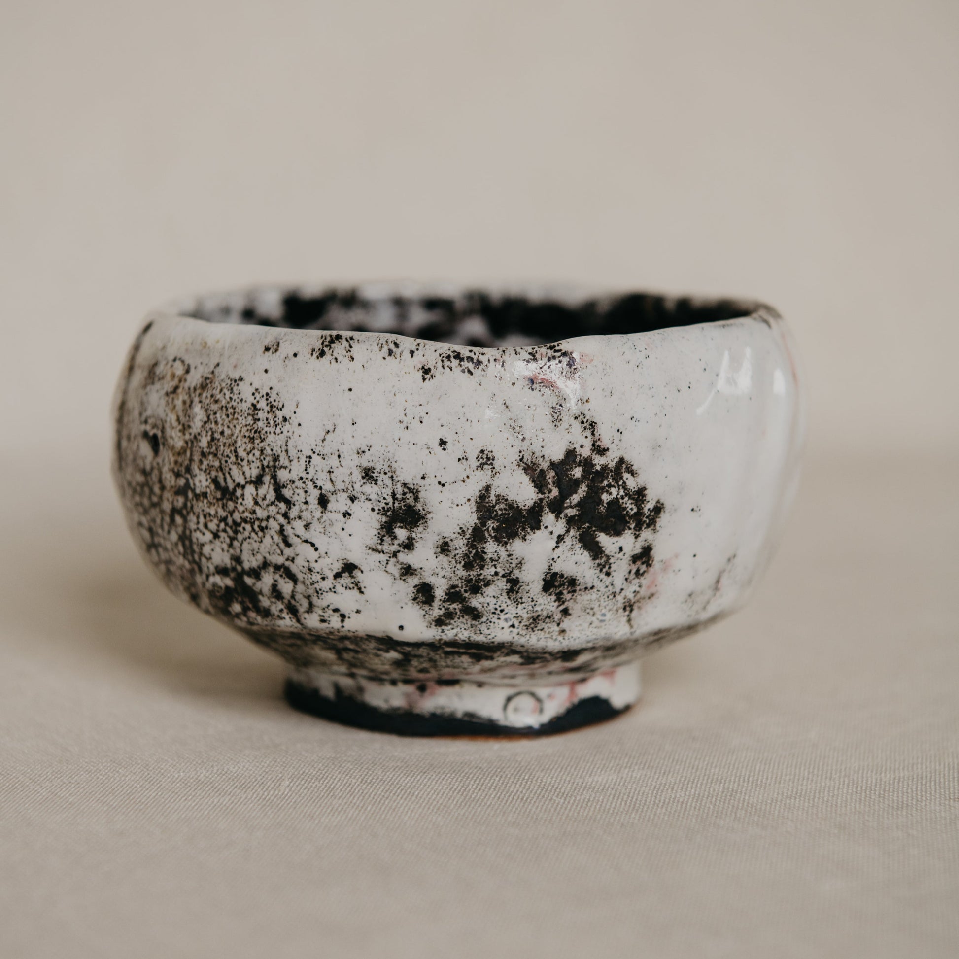 Ceramic bowl with a textured surface on a beige background