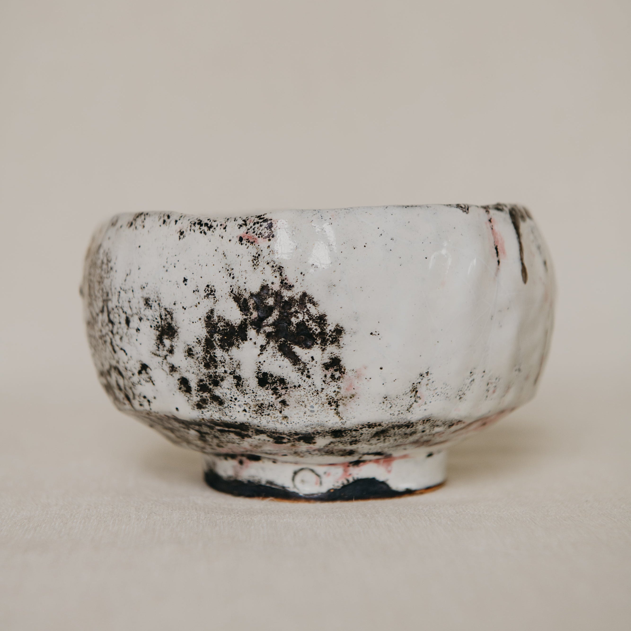 Ceramic bowl with textured surface on a plain background