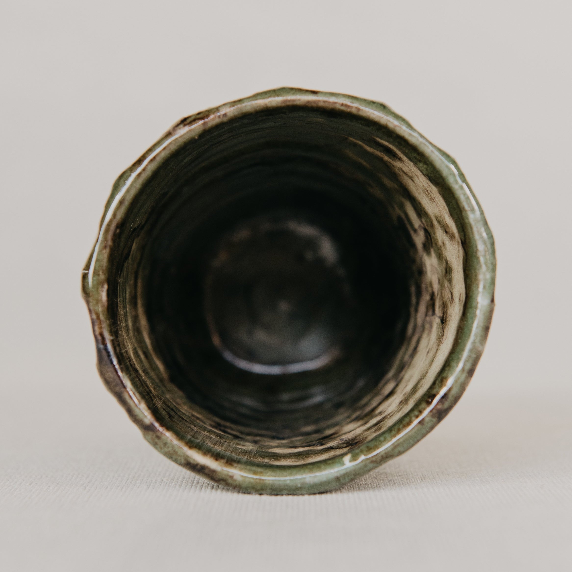 Ceramic vase with textured surface on a plain background