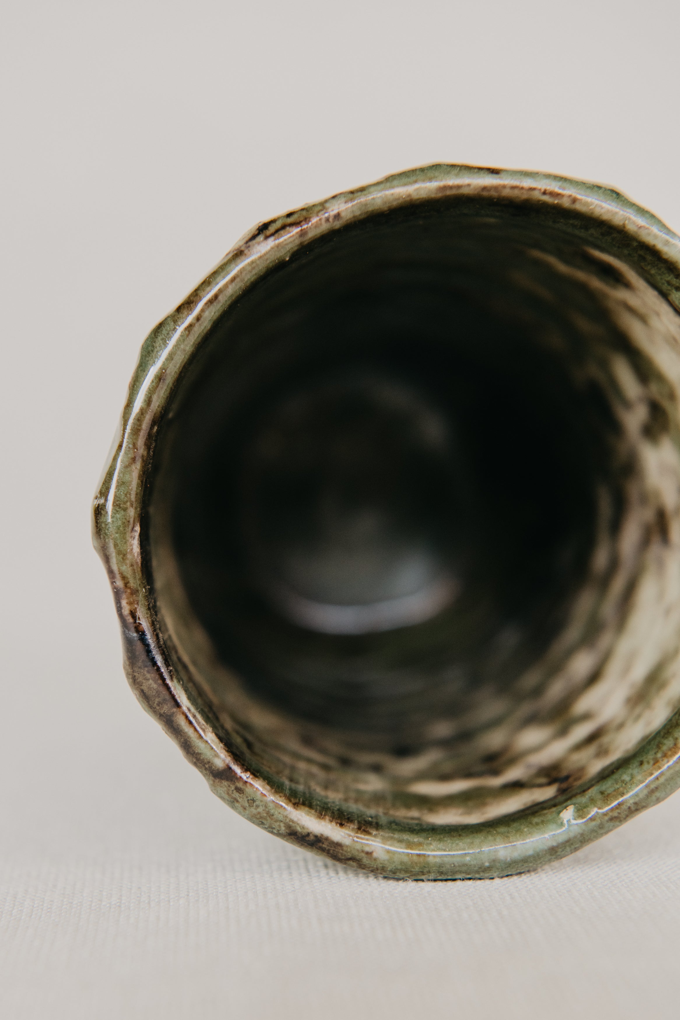 Close-up of a textured ceramic vase on a light background