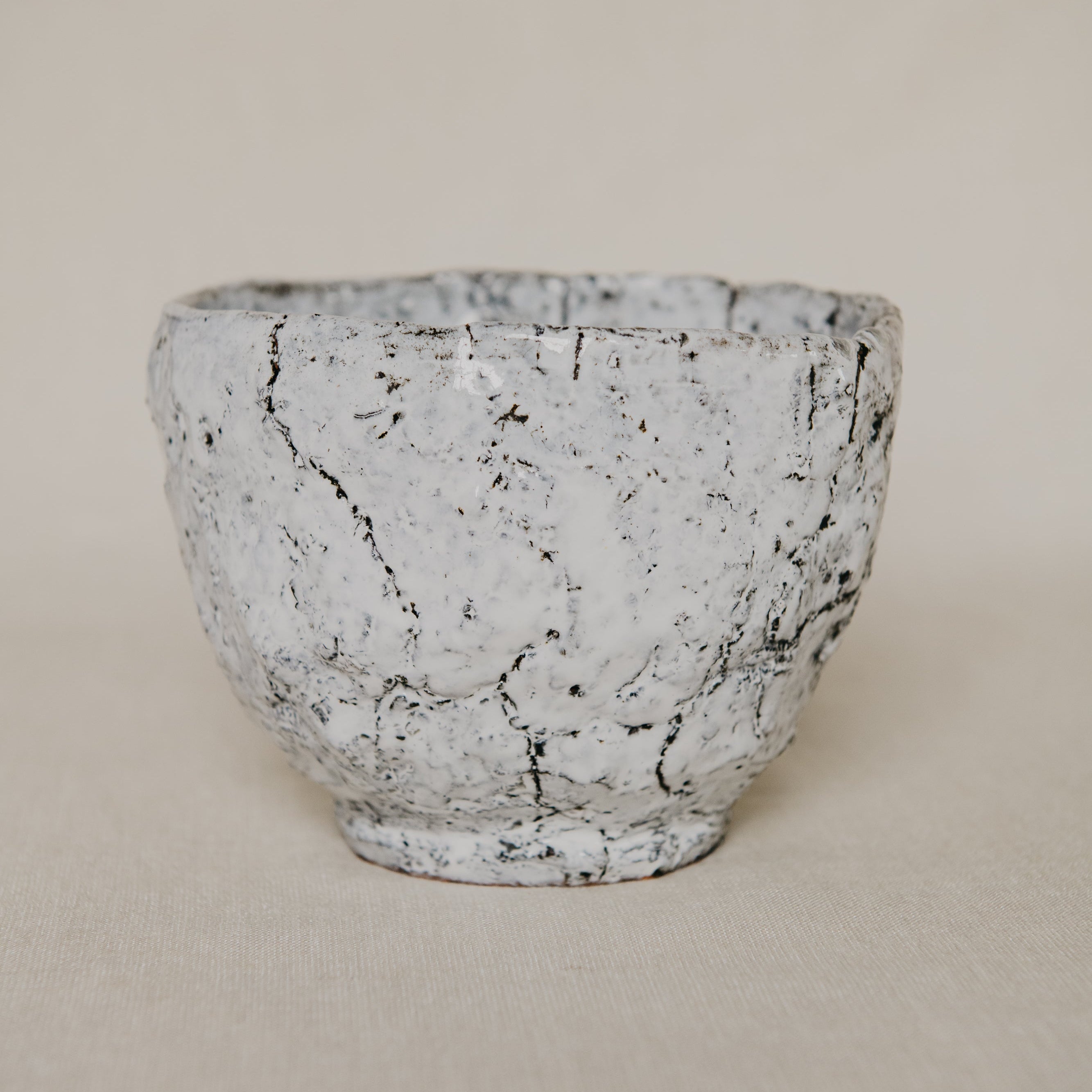 Marble-patterned ceramic bowl on a beige background