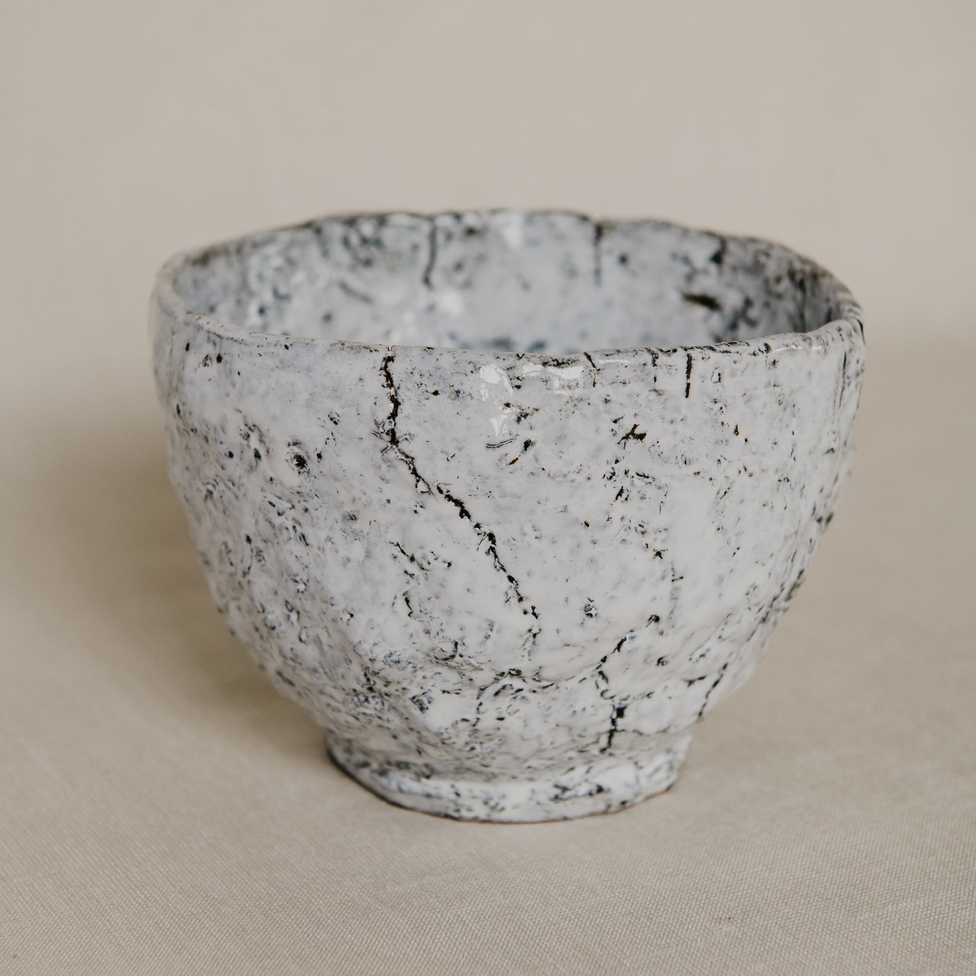 Textured ceramic bowl on a beige background