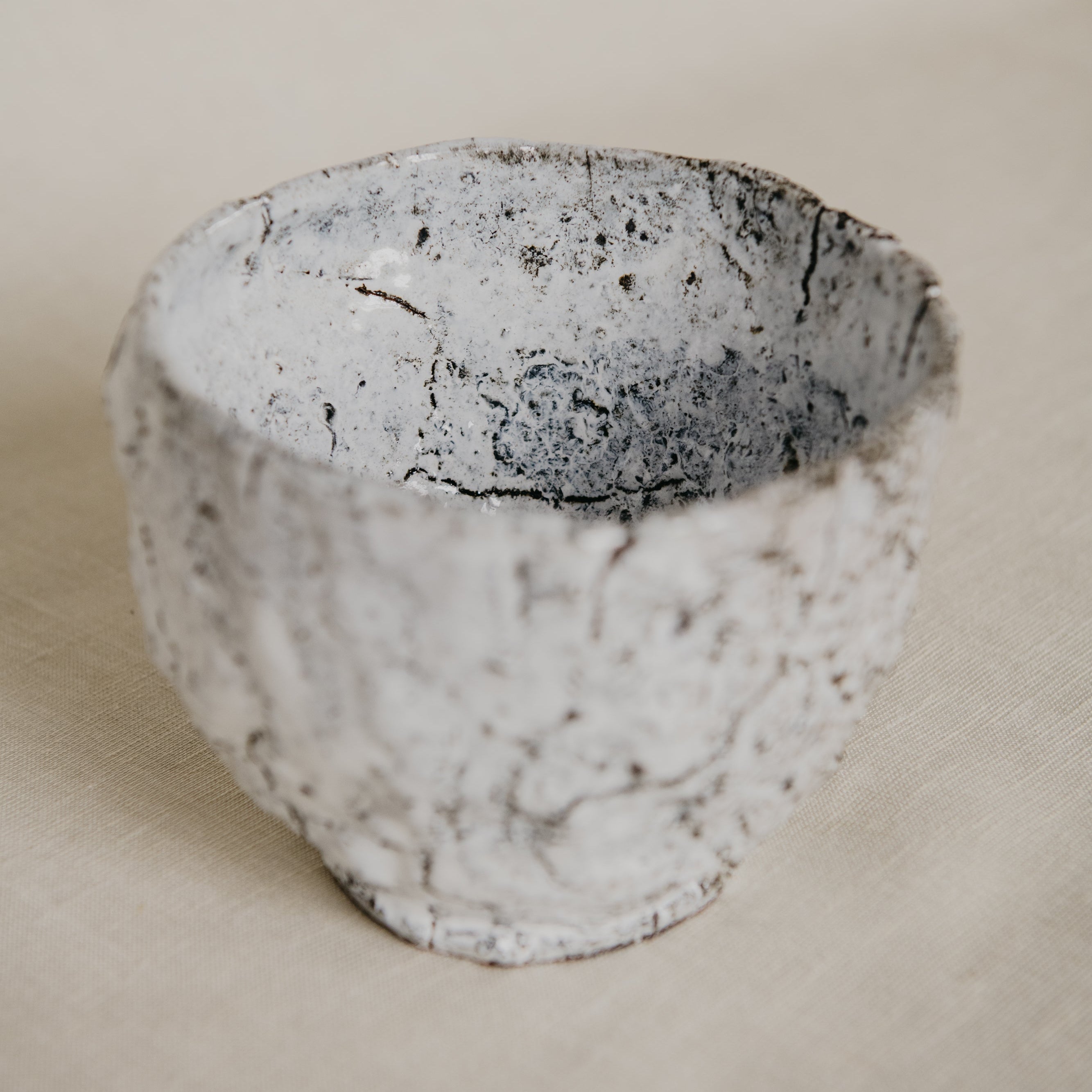 Ceramic bowl with textured surface on a beige background