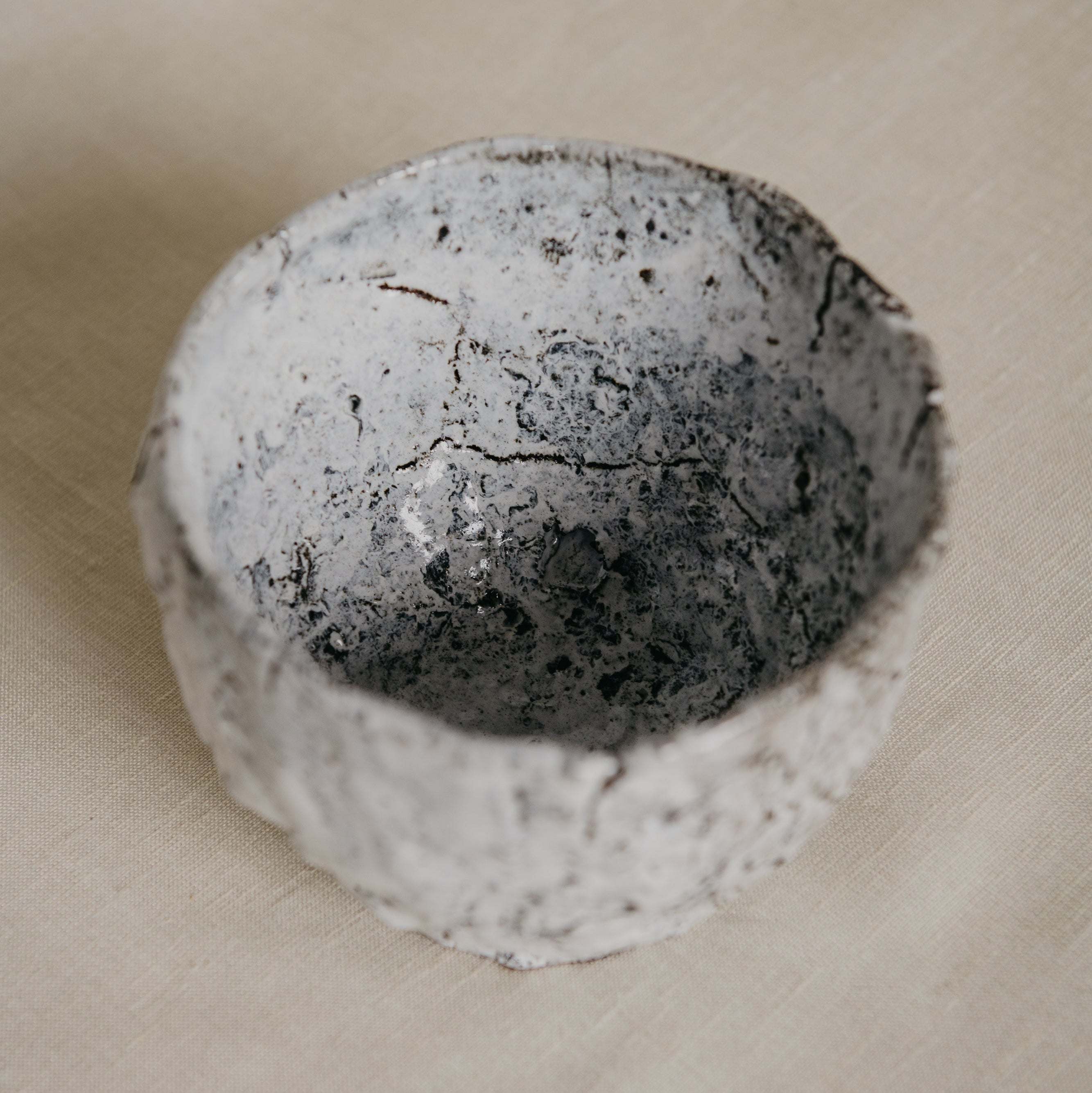 Round stone with a textured surface on a beige background