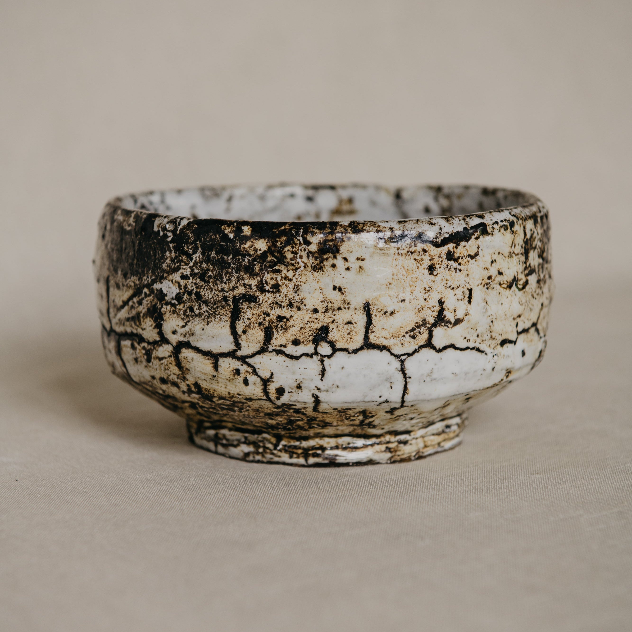 Ceramic bowl with a textured surface on a plain background