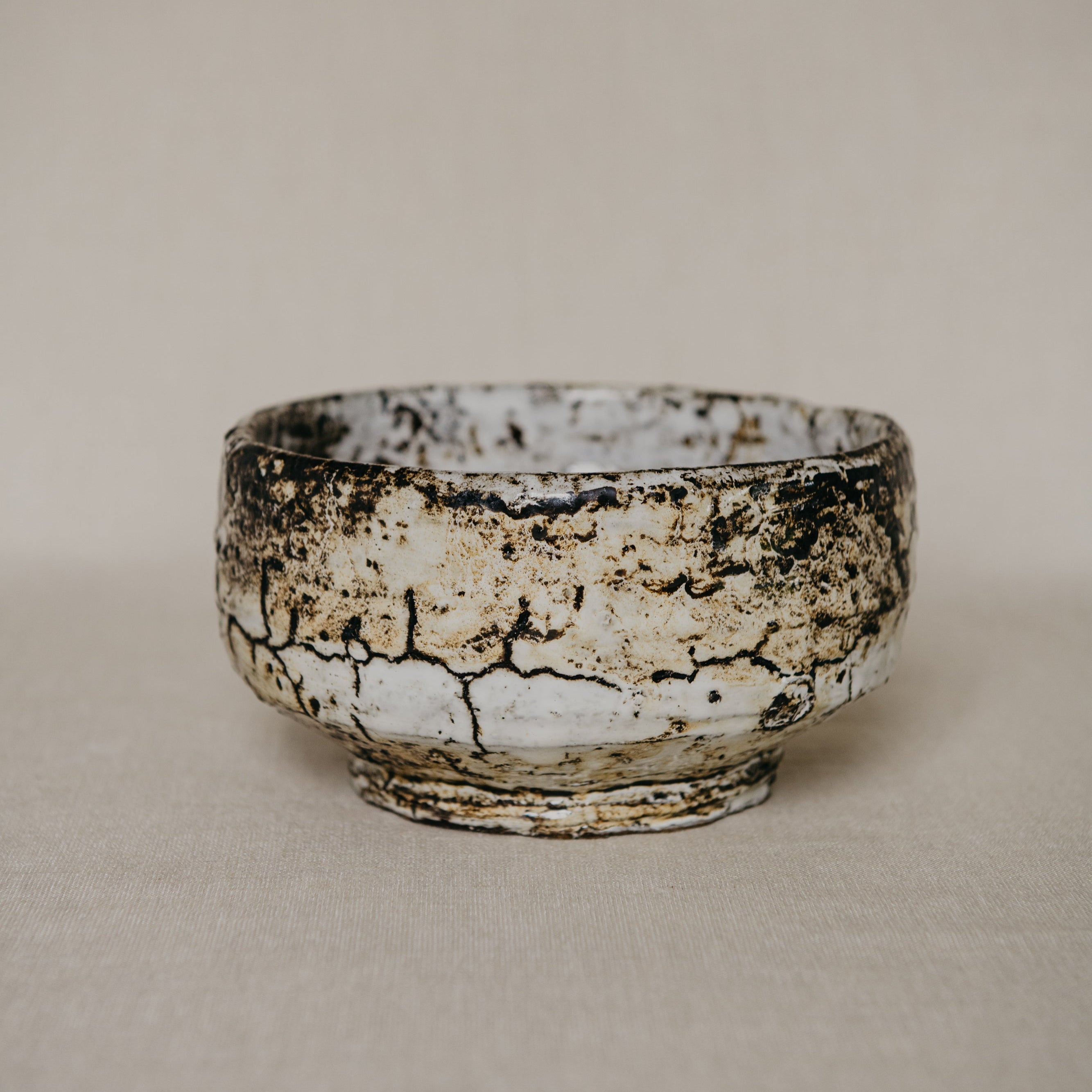 Ceramic bowl with a textured surface on a plain background
