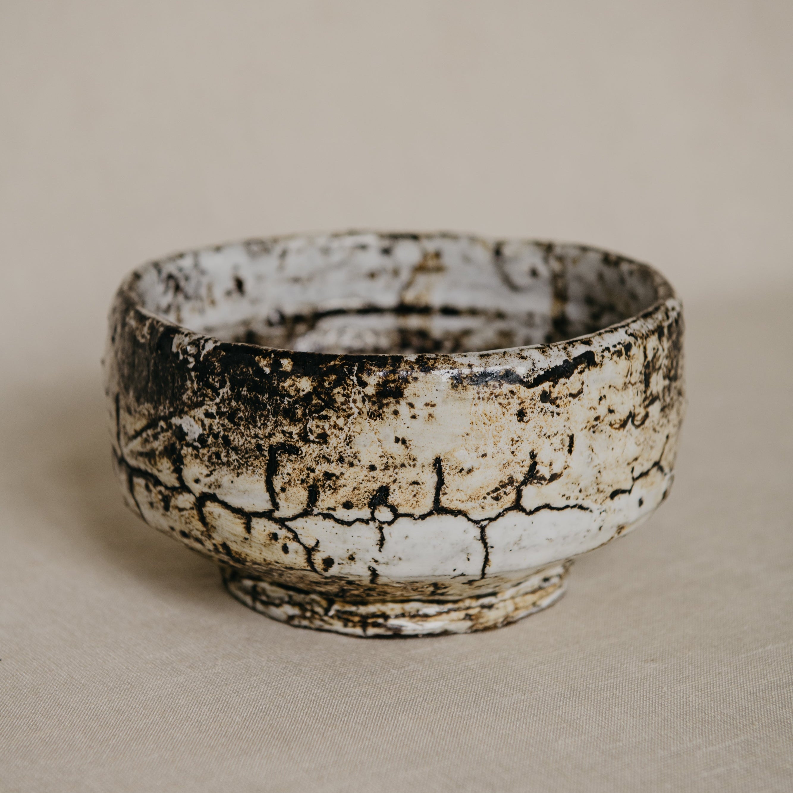 Ceramic bowl with a textured surface on a beige background