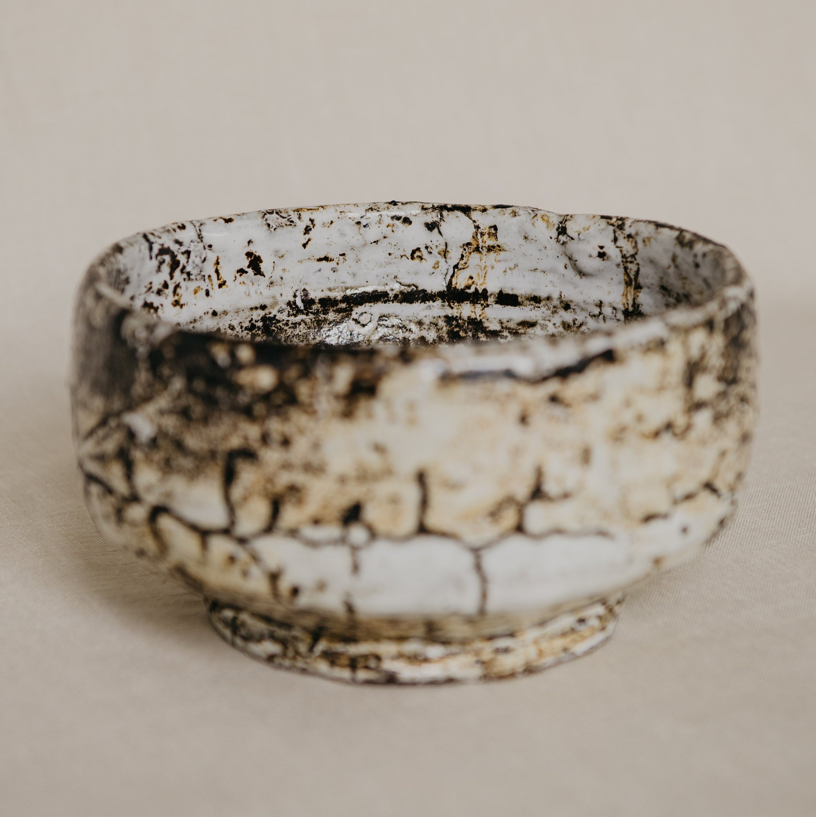 Ceramic bowl with a textured surface on a beige background