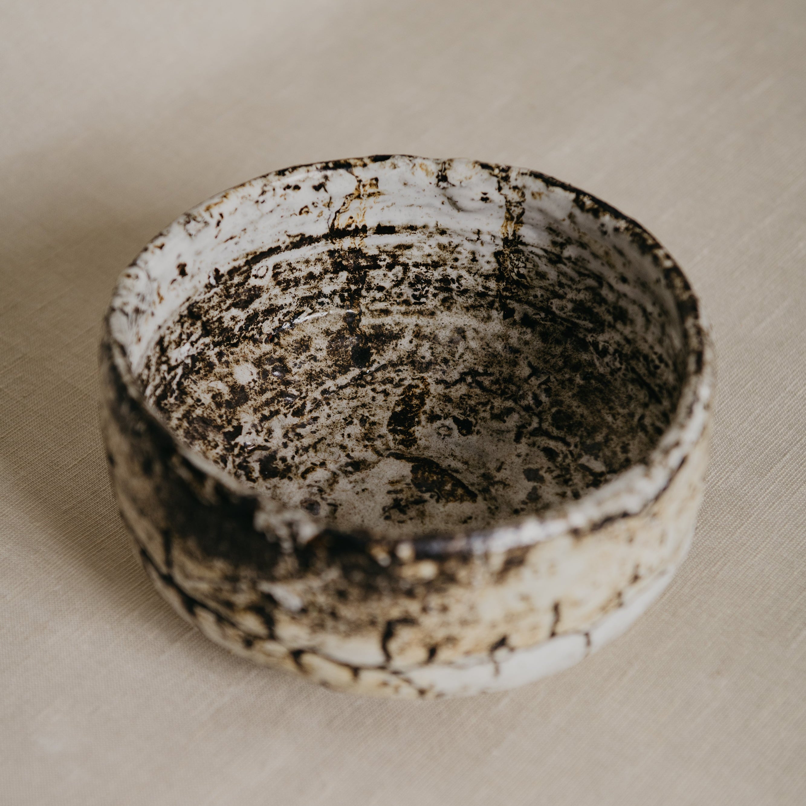 Ceramic bowl with textured surface on a beige background