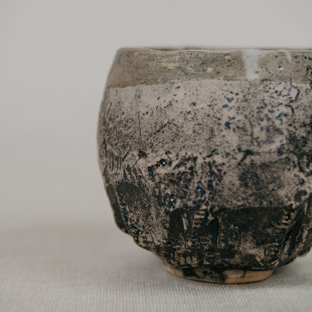Textured ceramic bowl on a light gray background