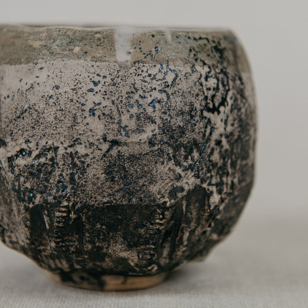 Ceramic bowl with textured surface on a neutral background