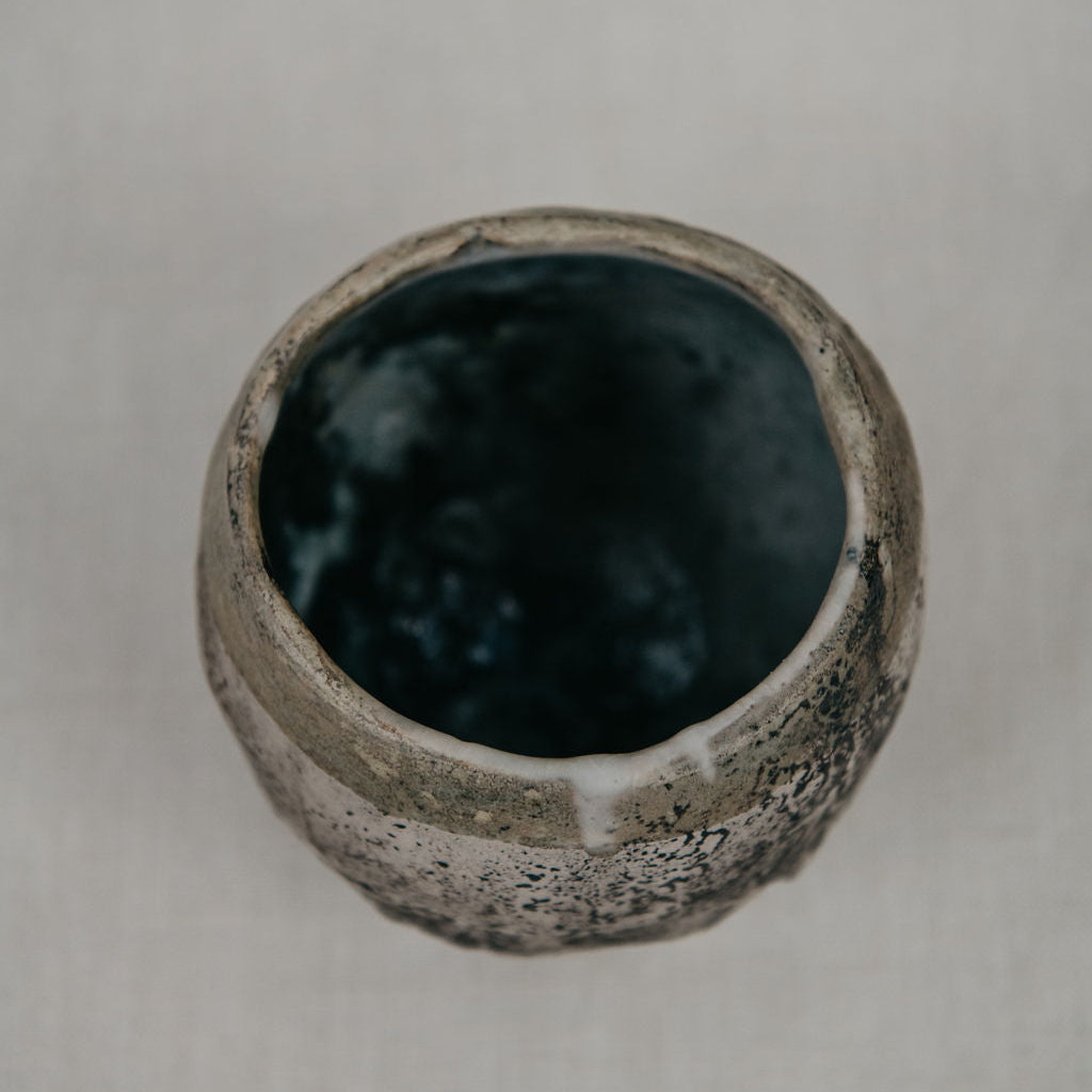 Ceramic bowl with textured surface on a plain background