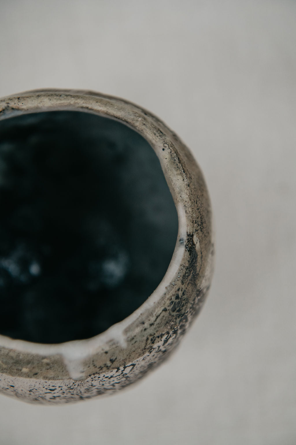 Close-up of a textured ceramic bowl on a neutral background