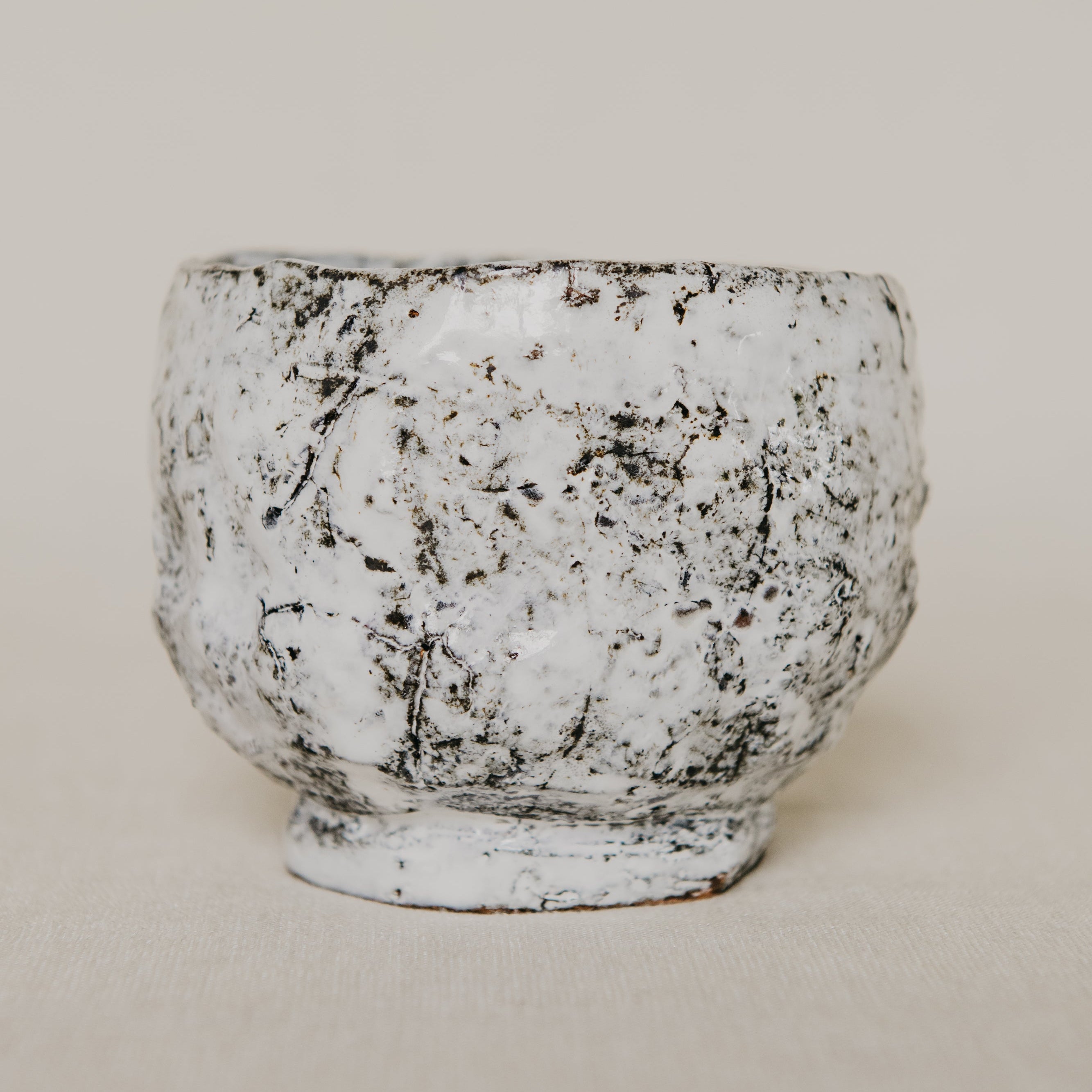 Textured ceramic bowl on a beige background