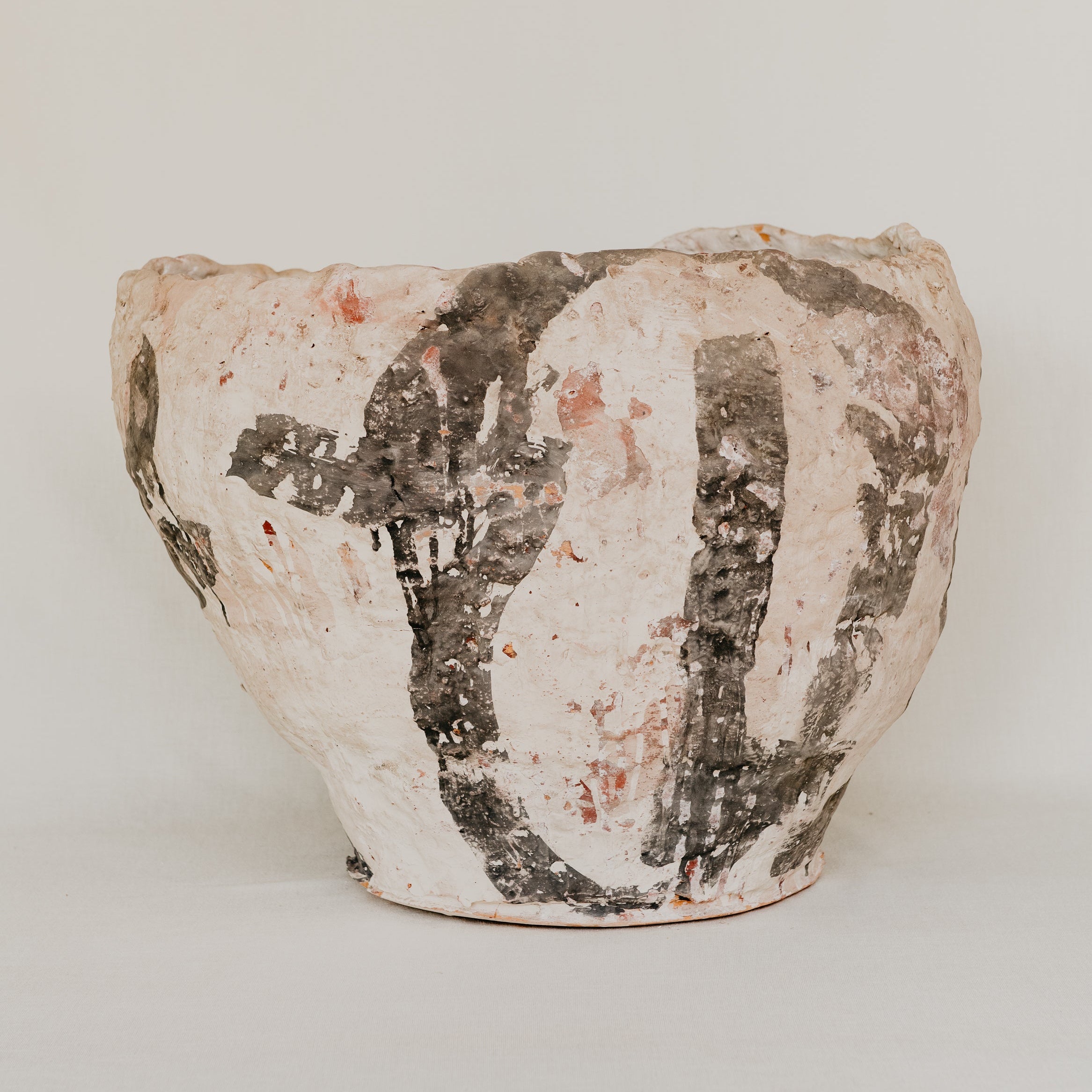 Ceramic pot with textured surface on a plain background