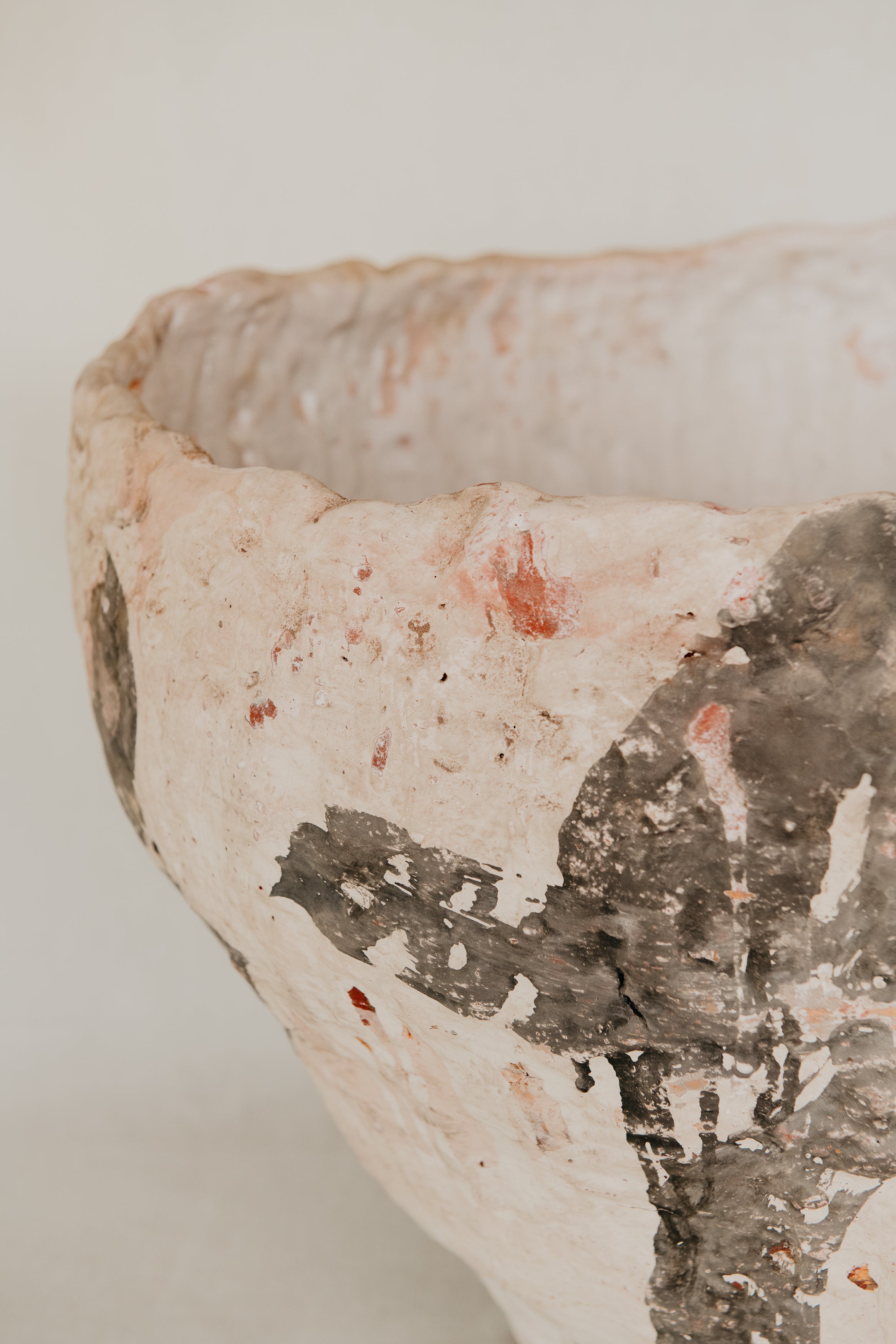 Close-up of a ceramic bowl with textured surface on a light background