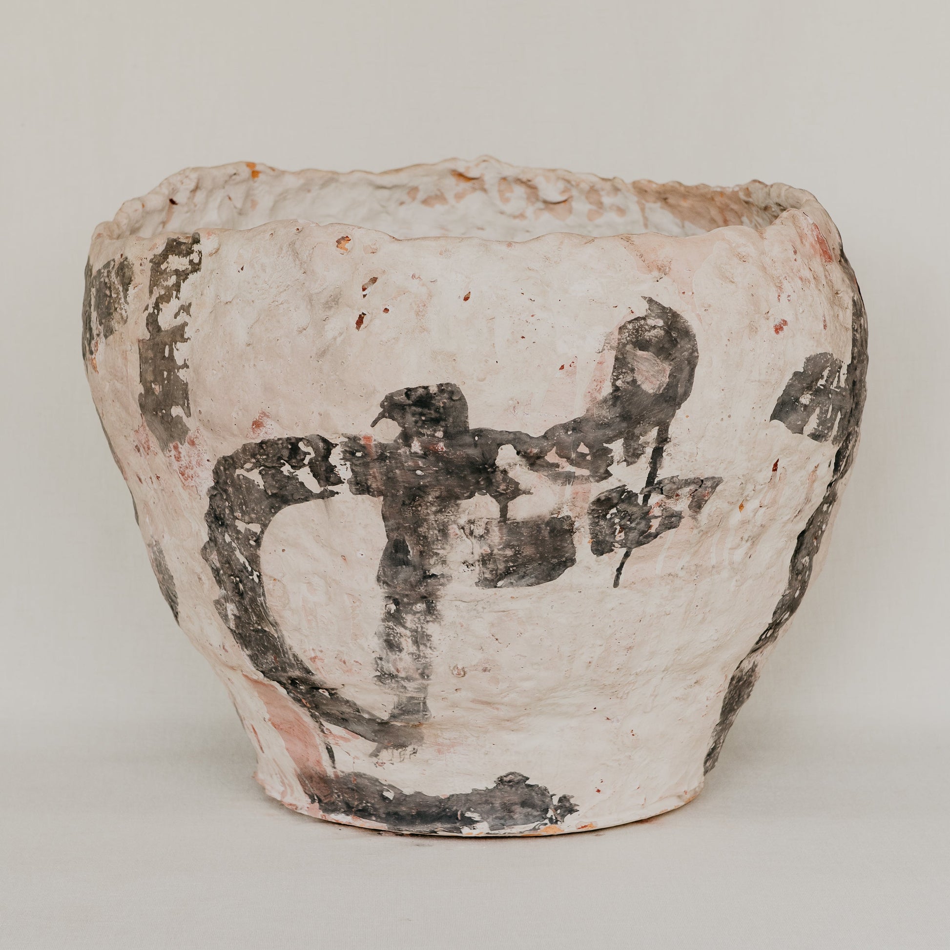 Ceramic jar with black design on a white background