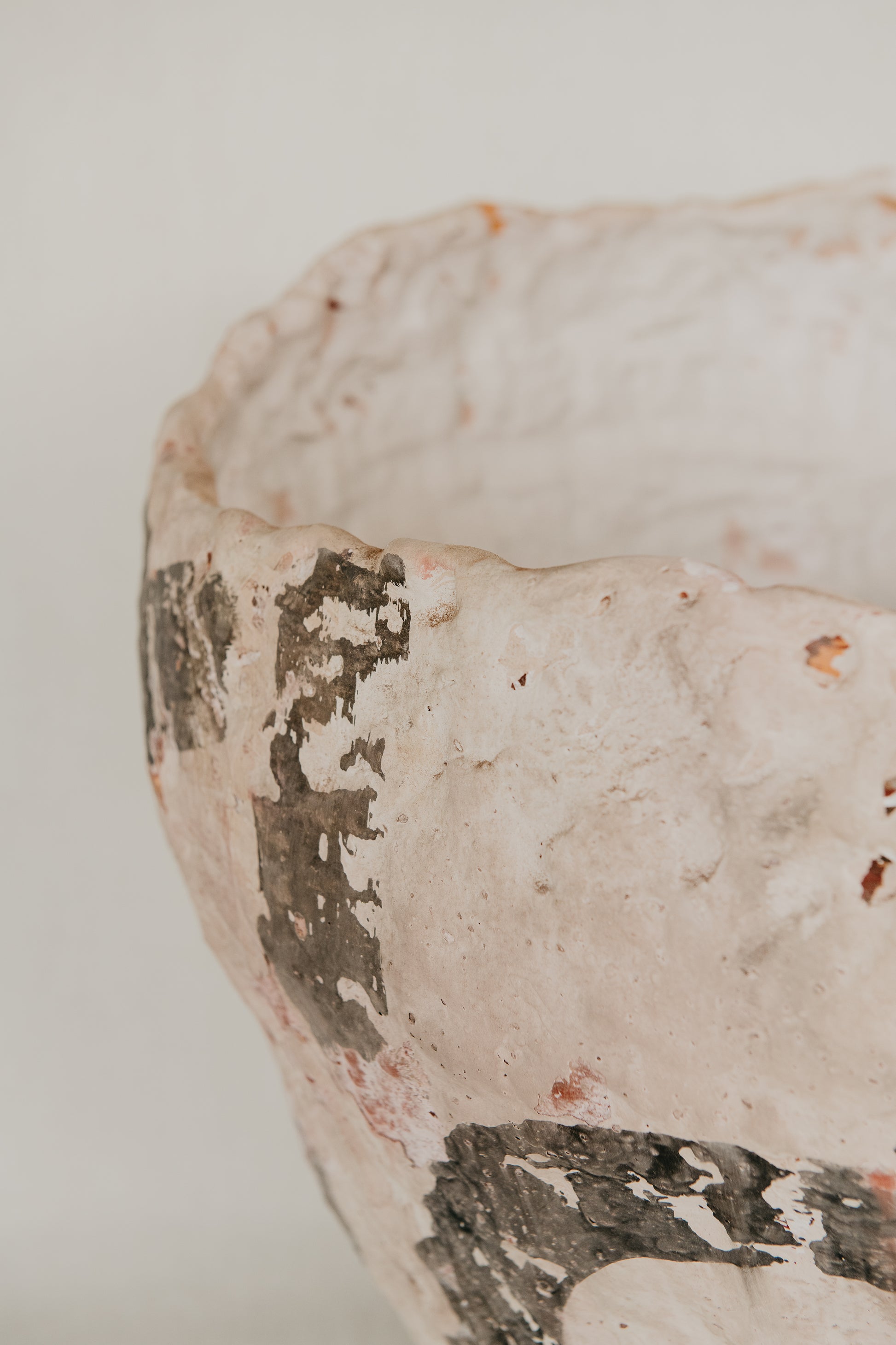 Close-up of a textured ceramic bowl with a white background