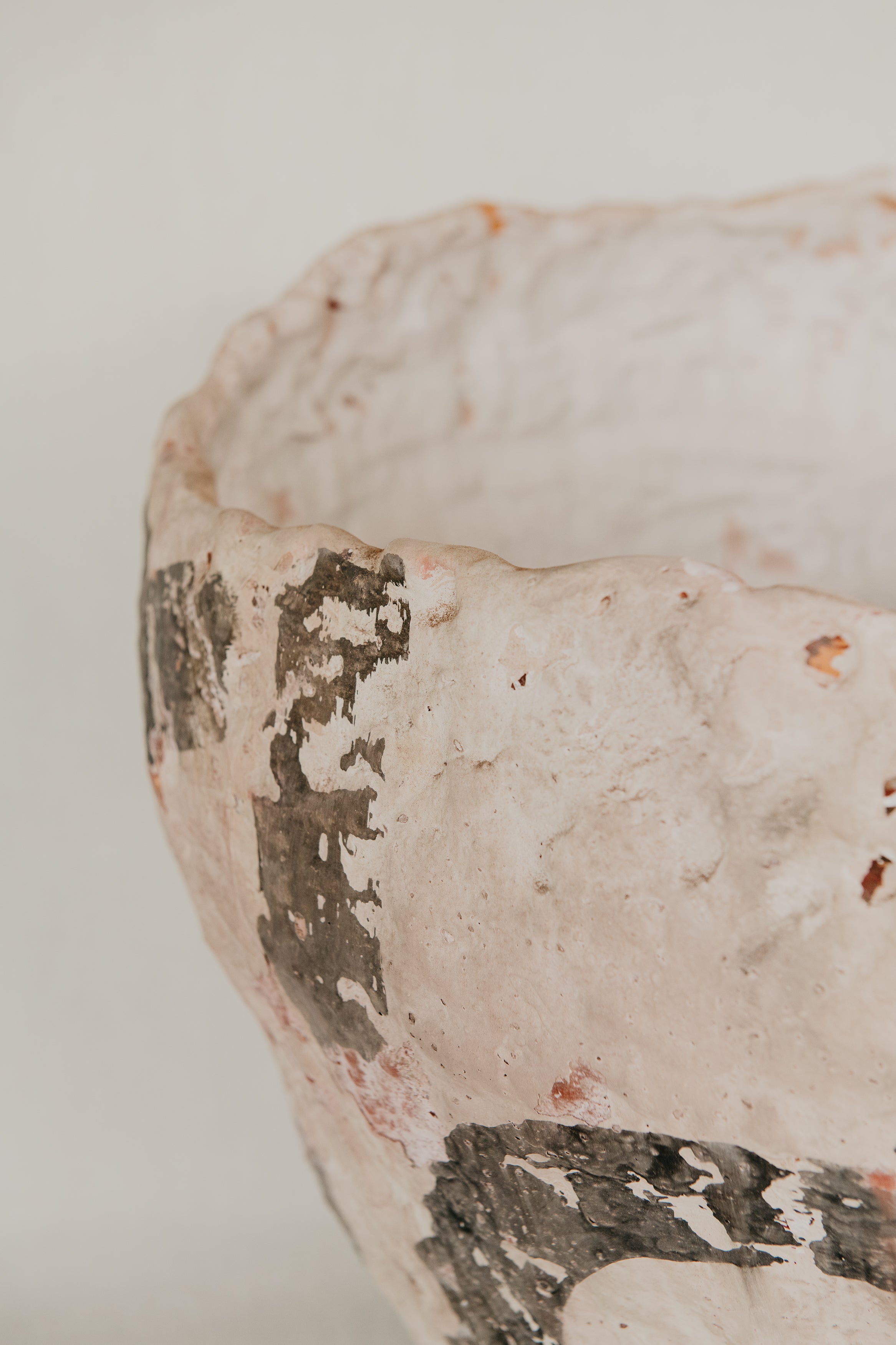 Close-up of a textured ceramic bowl with a white background