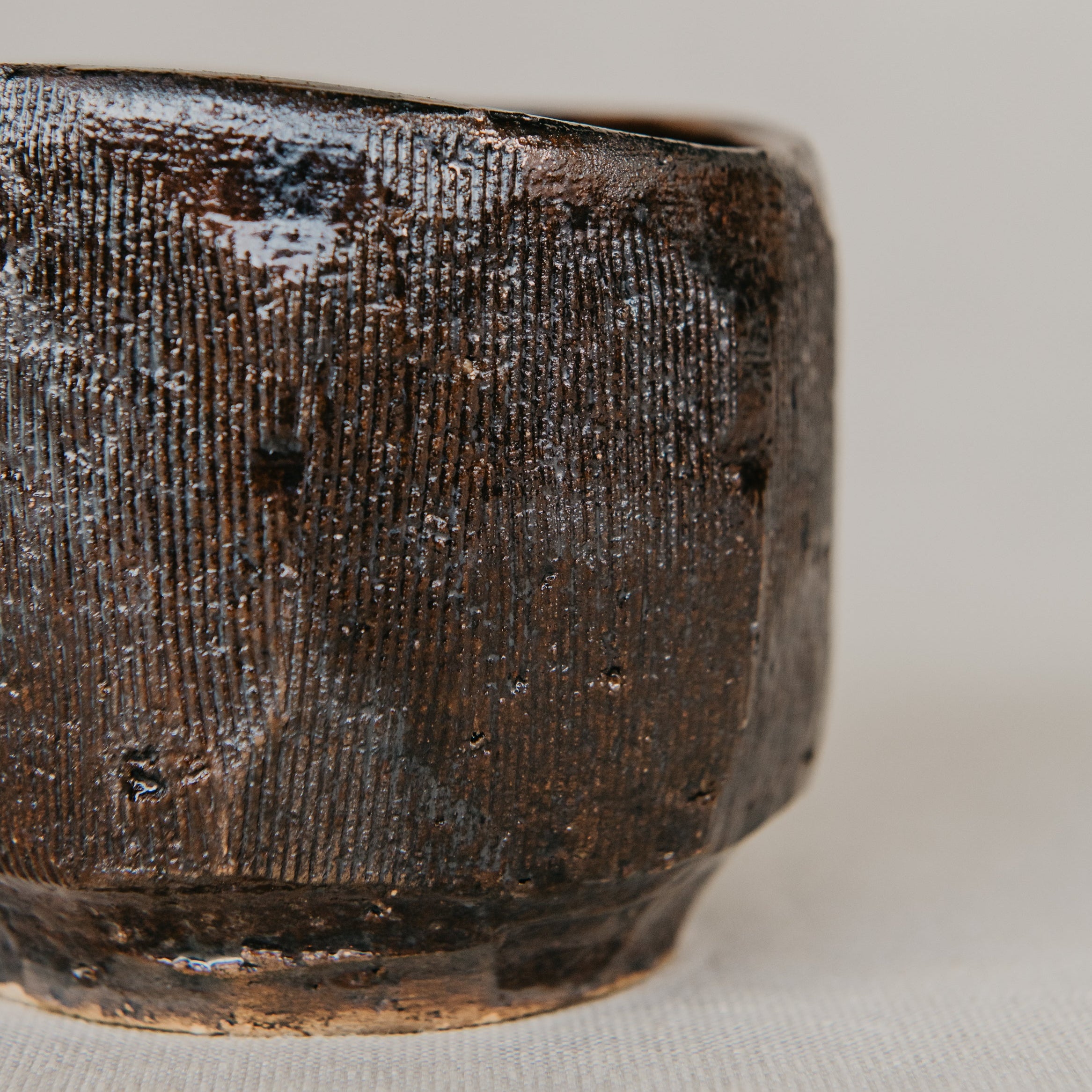 Close-up of a textured ceramic bowl on a light background