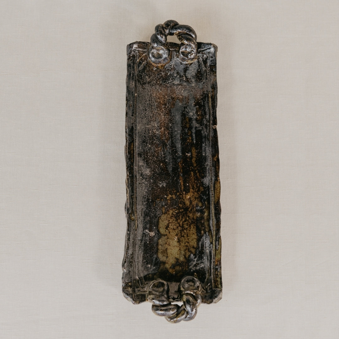 Decorative object with intricate designs on a plain background