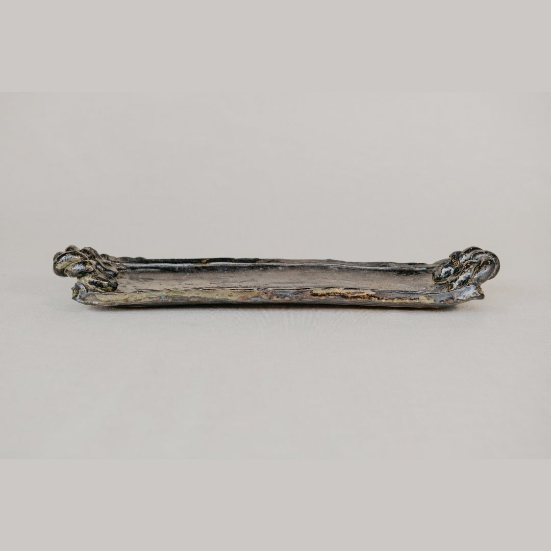 Decorative brown tray on a light gray background