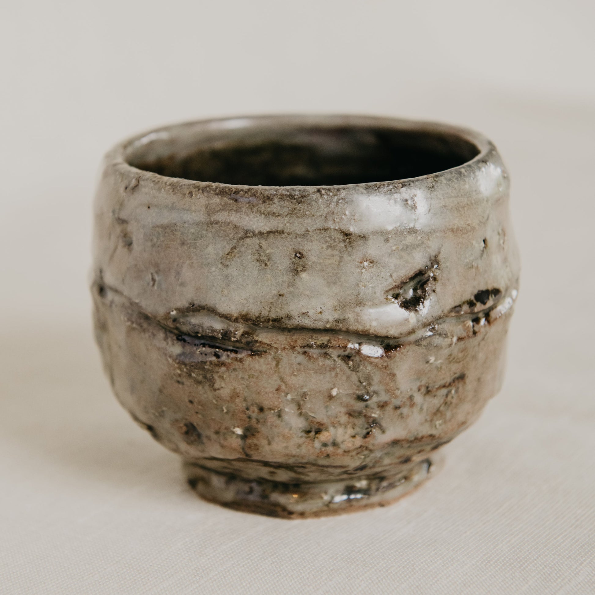 Ceramic cup with a textured surface on a plain background