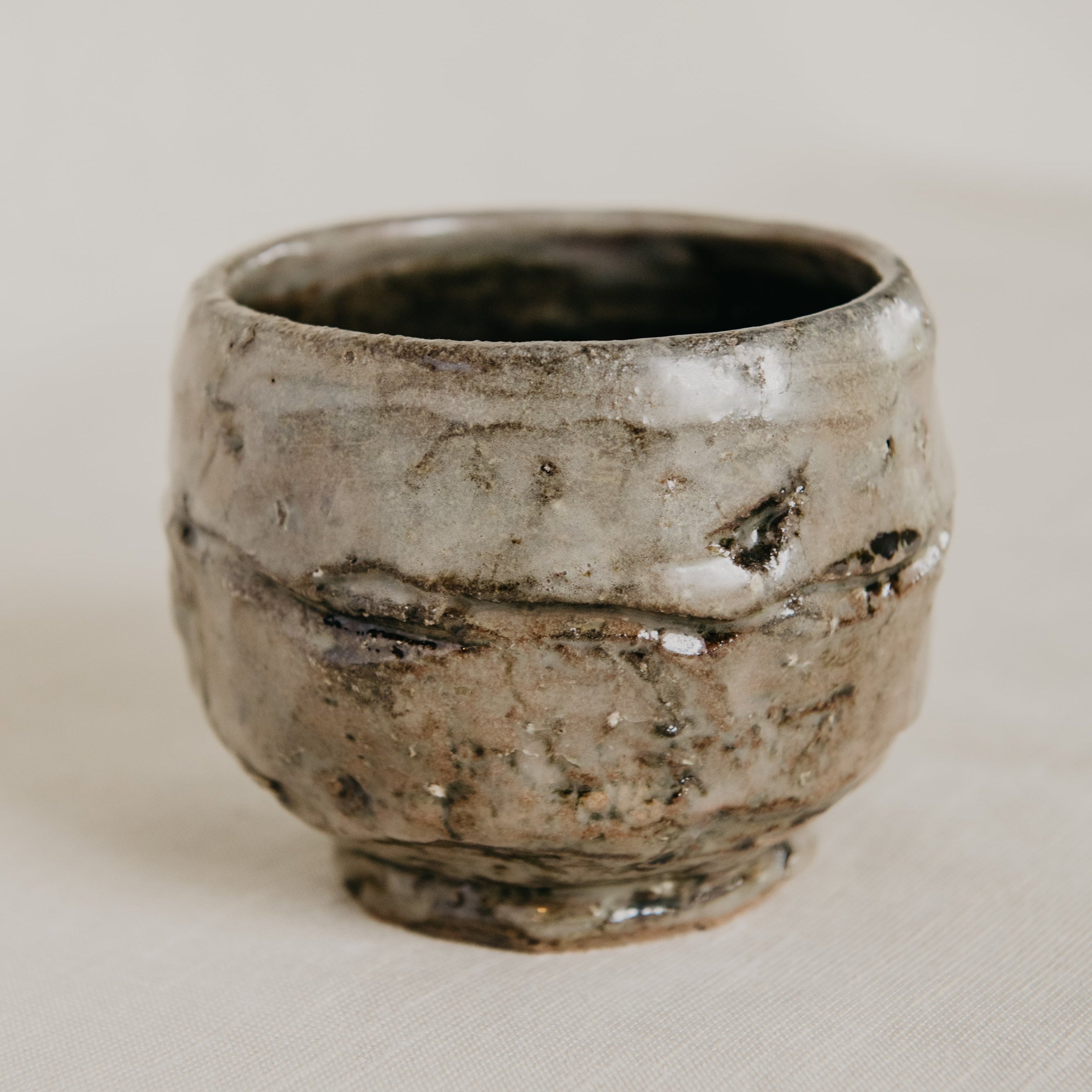 Ceramic cup with a textured surface on a plain background