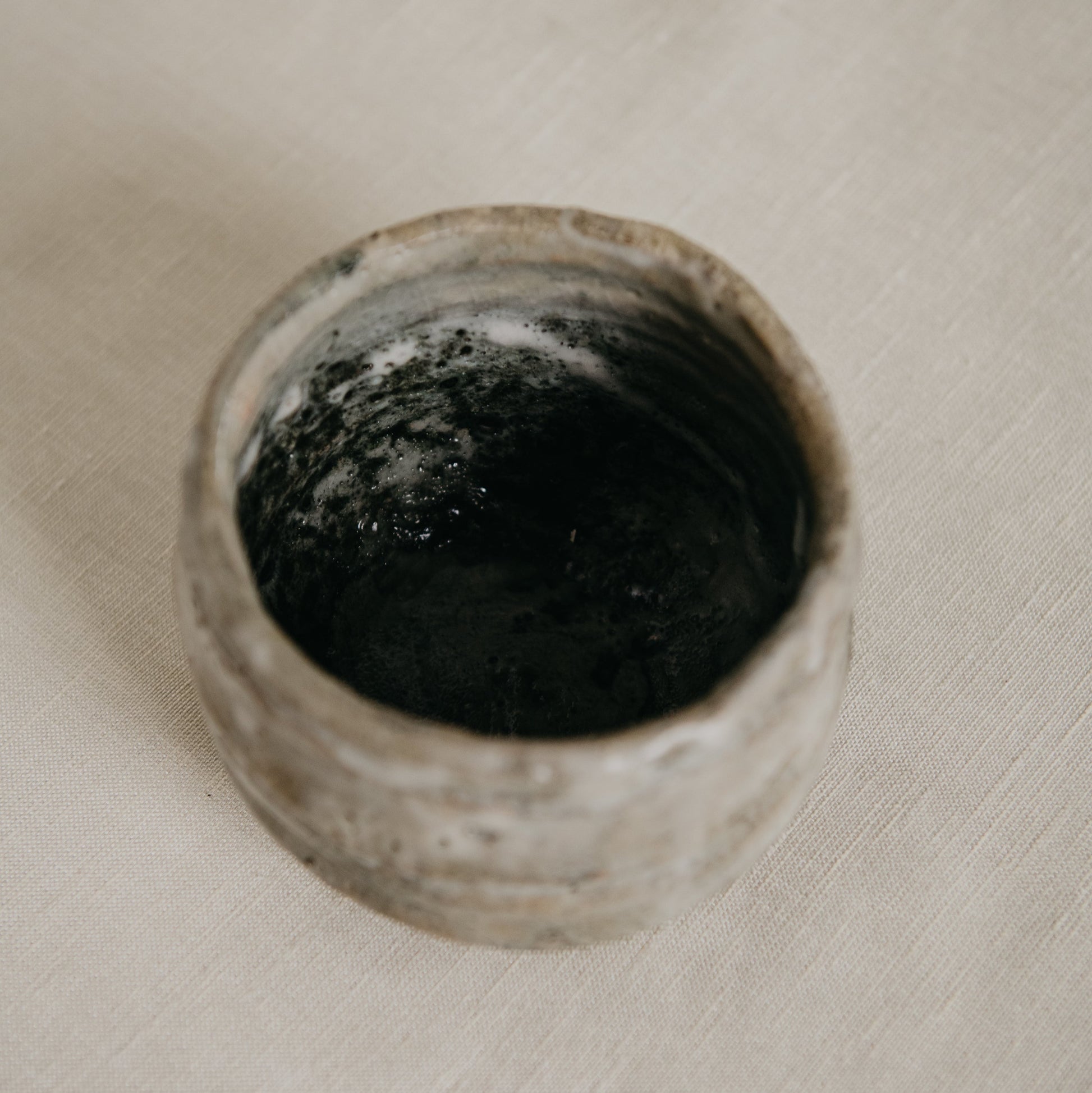 Close-up of a dirty drain on a light-colored surface